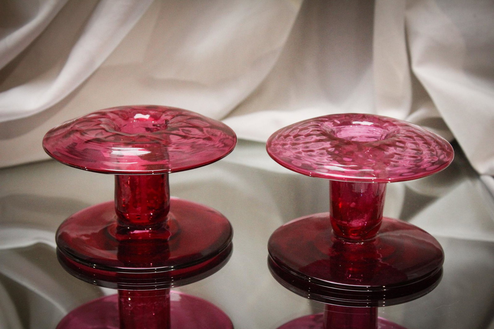 Pairpoint Glass Red/ Pink Etched 3 pc. Console Set: Attributed to Pairpoint or in the style of, this console set is nice. Three pieces of sheer delight. Unusual red to pink coloring. Bowl is etched and candlesticks are plain. Largest measures 3 1/2" by