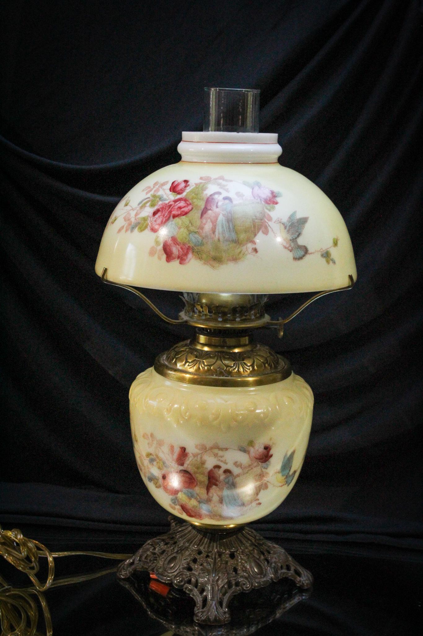 Victorian Glass courting Couple Parlor Lamp: Pastel yellow is the background for this attractive Victorian parlor oil lamp adorned with a courting couple on one side and floral dÃ©cor on the reverse. Lamp has been electrified. Measures 18" tal