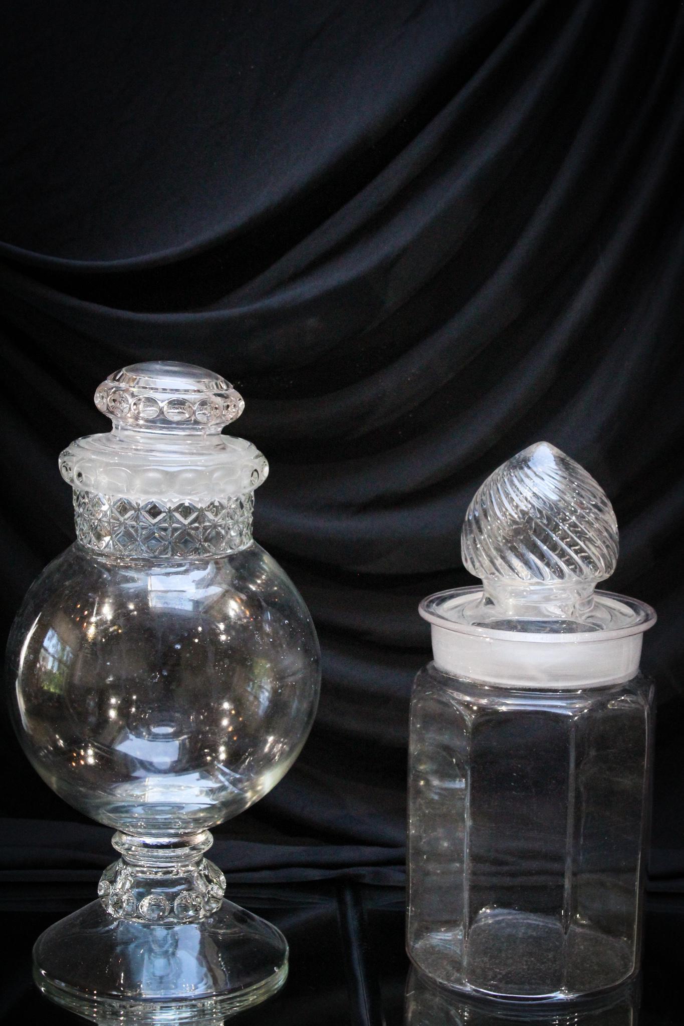 2 pc. Lot Glass Apothecary Jars: Lot of 2 glass apothecary jars- one in the Mascotte pattern. Tallest measures 14".