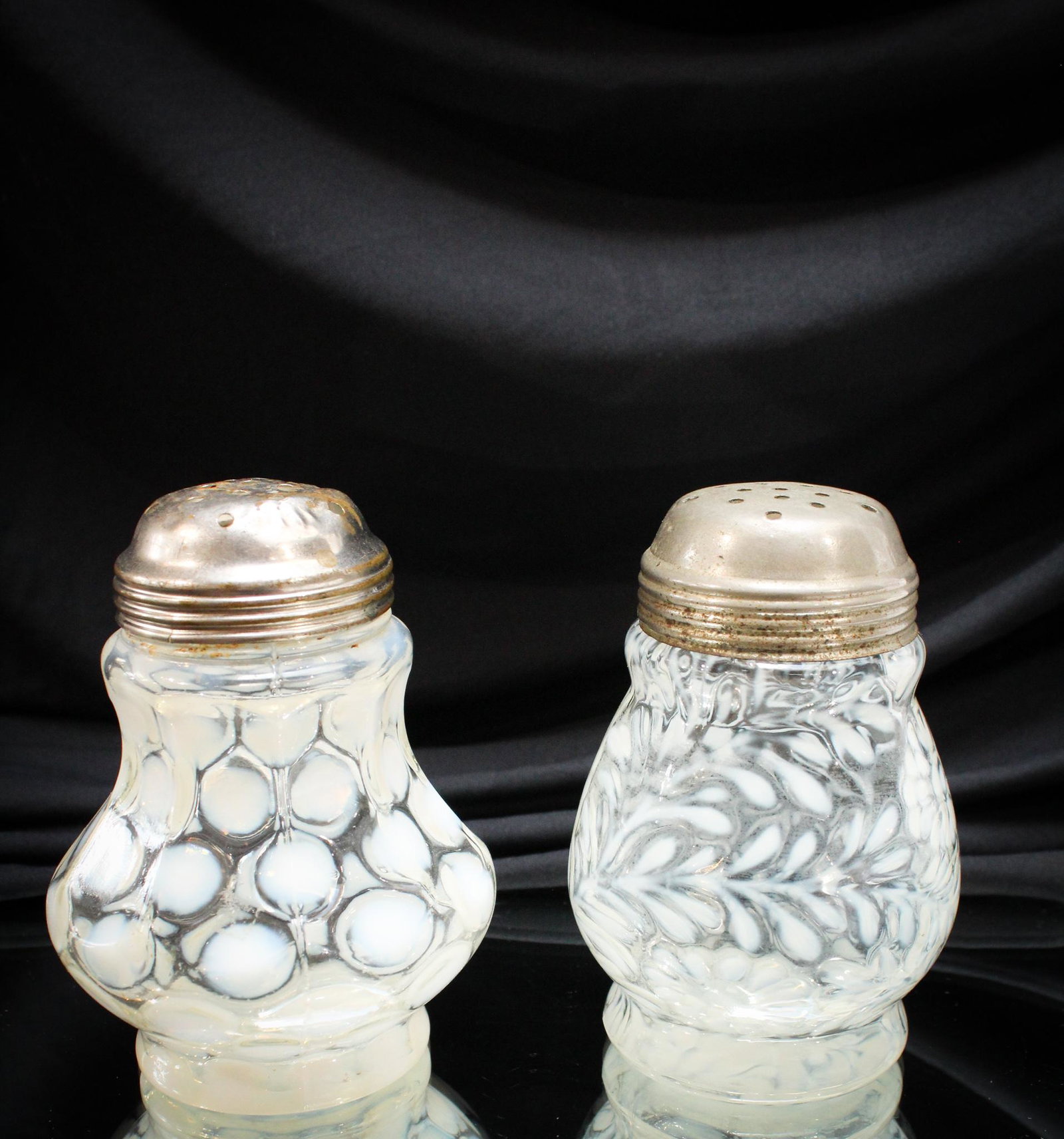 2 pc Lot Victorian Opalescent Glass Sugar Shakers: Two of the finest Victorian sugar shakers. Yes, they are around. But these are really nice examples of the Spanish Lace pattern and coin spot. Tallest measures 5".