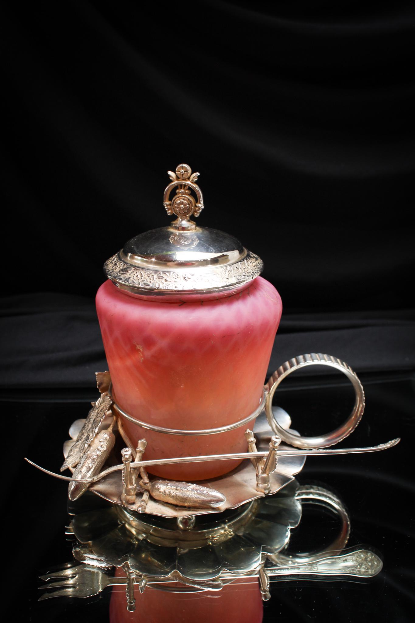 Derby Silverplate Pink Satin Glass Pickle Castor: Even Helen Keller could tell this piece was used for pickles. That's right. This fabulous Victorian castor frame is adorned with figural gerkins and foliage. Complete with fork. The jar is a cotton ca