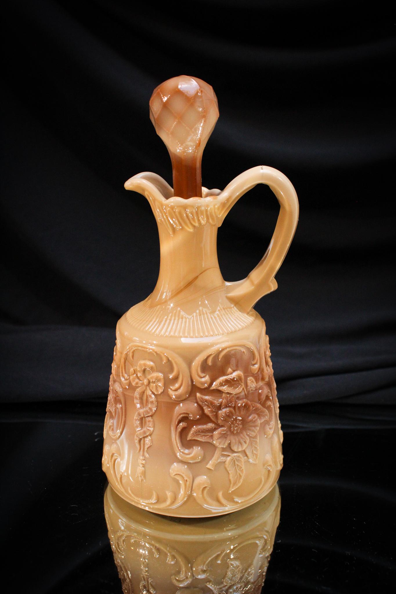 Victorian Chocolate Glass Wild Rose & Bowknot Cruet: Another lovely here is offered. A chocolate glass Wild Rose with Bowknot Victorian cruet. Complete with original stopper. It measures a staggering 7" tall.