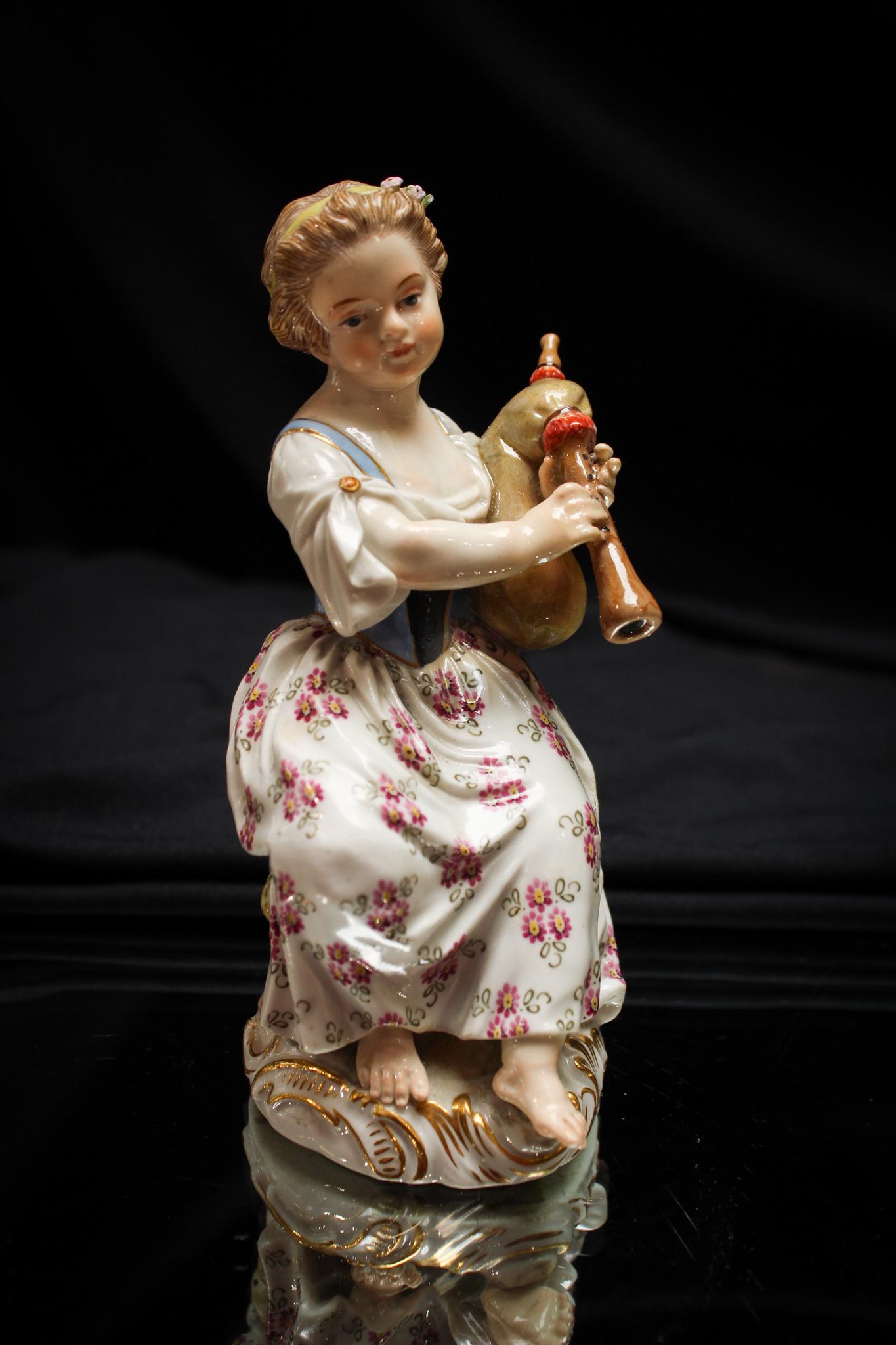 Meissen Porcelain Female Bagpiper Figurine: Delicate Meissen girl playing a bagpipe figurine. Lovely piece of porcelain. It measures 5" tall.