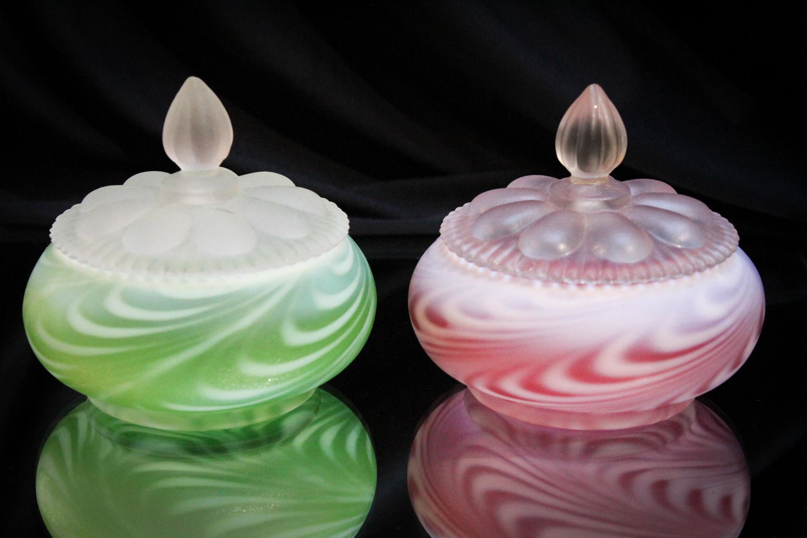 2 pc Lot Fenton Art Glass Green & Cranberry Swirled Feather: This is always a favorite among you collectors. Two-piece lot of Fenton art glass swirled feather pattern in cranberry and green covered powders. Tallest measures 3 1/2".