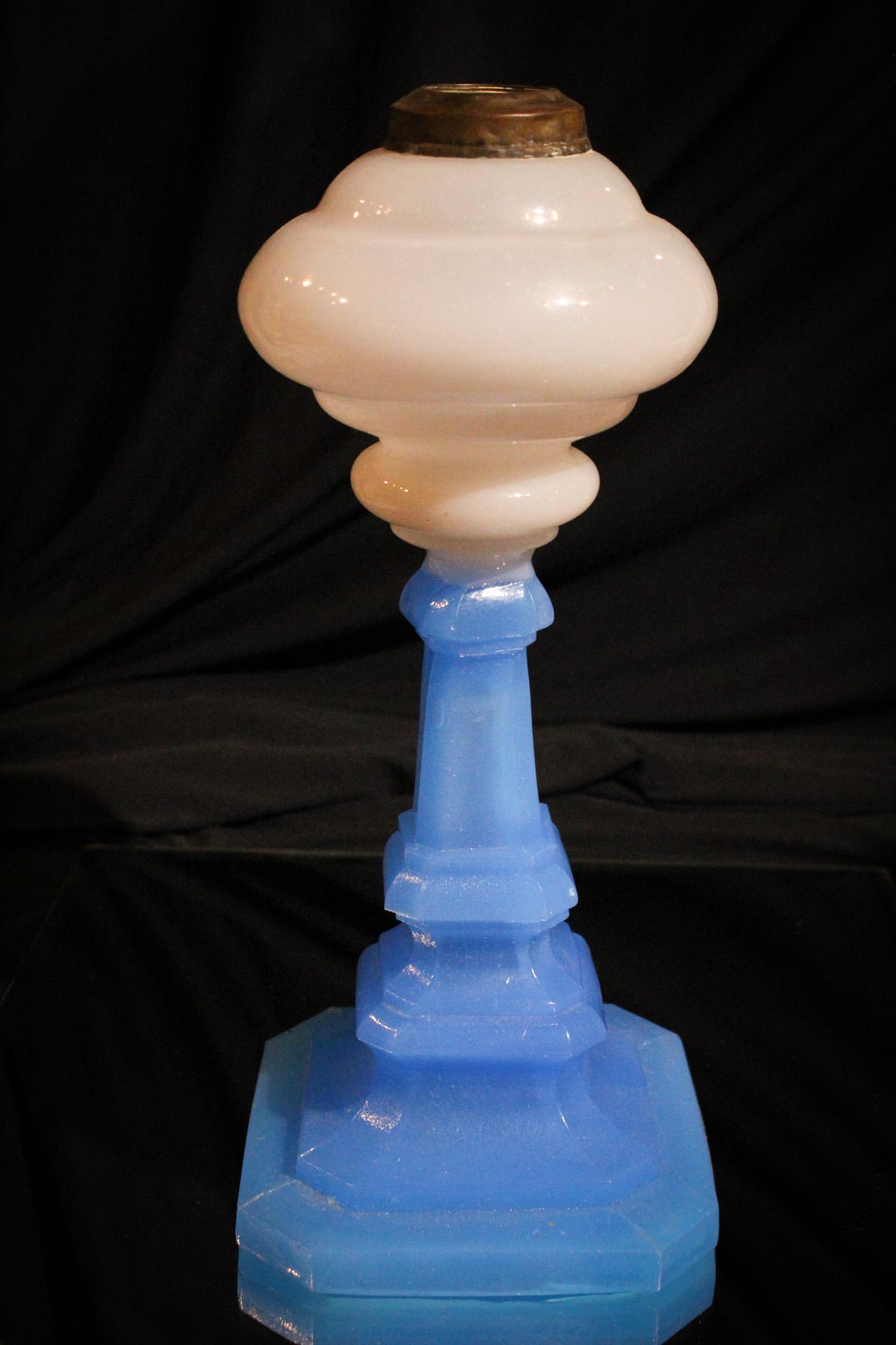 Sandwich Attributed Blue Opal Clambroth Victorian Oil Lamp: Attributed to Sandwich glass, this oil lamp of the Victorian period is comprised of clambroth and blue opal glass. Classic form. It measures 12" tall.