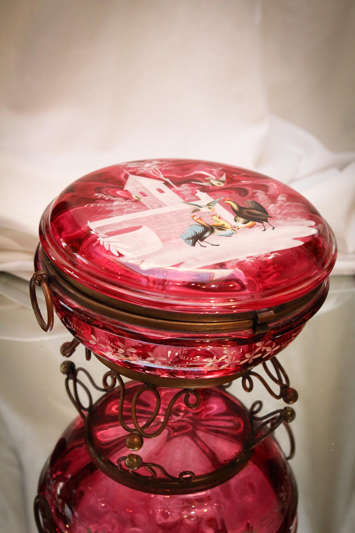 Rooster & Hens Cranberry Enameled Victorian Glass Jewelry Casket: Folks, this is a rare piece. A seldom ever seen enamel decoration of a rooster and hens and family. Deep rich cranberry coloring and ormulu feet makes this even more special. It measures 4 1/2" tall, 
