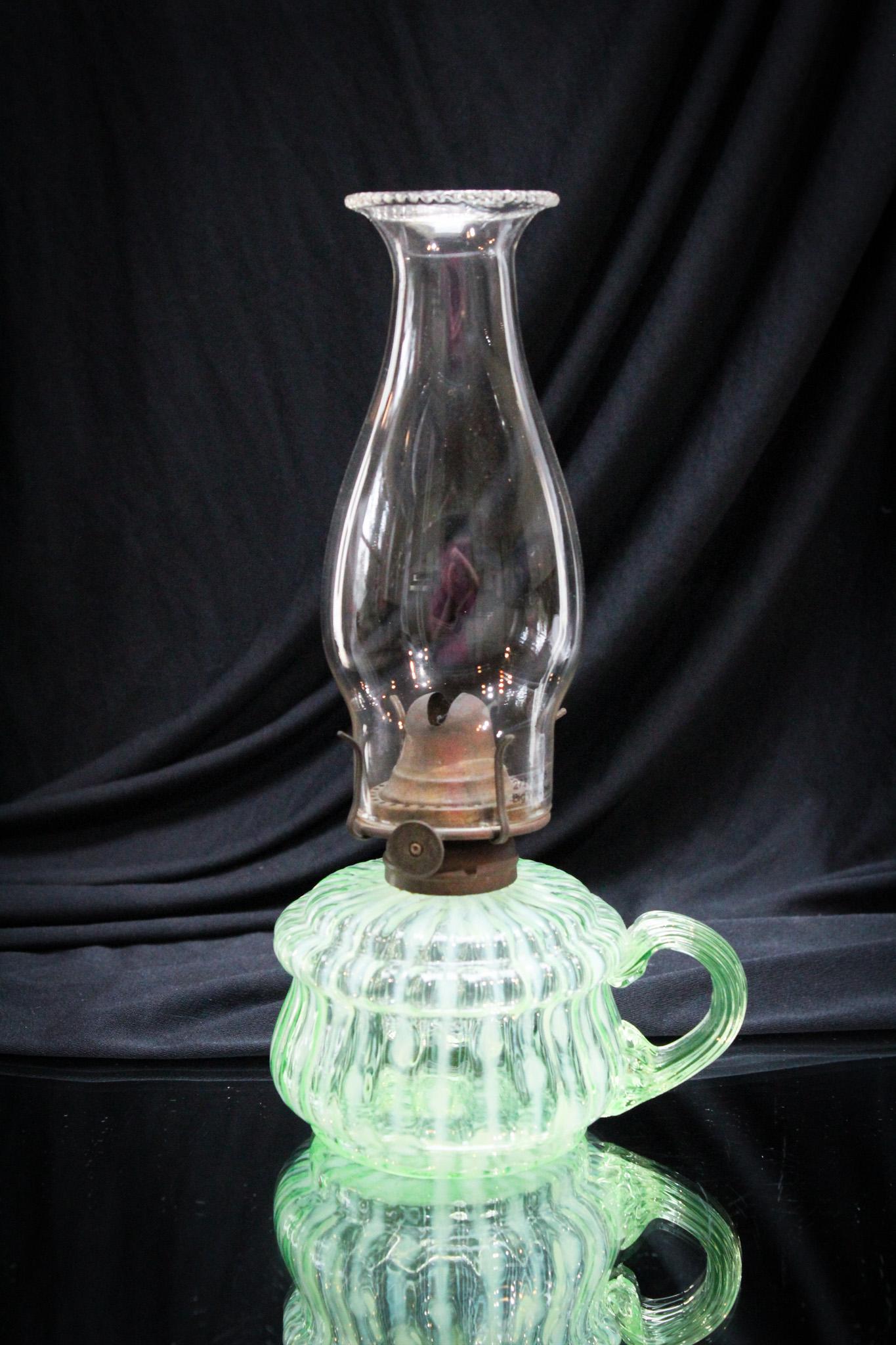 Uranium Green Opalescent Victorian Finger Oil Lamp: This one is so unusual. Boy does it light up too! Amazing piece, proudly presented by Magnum Auctions. Your source of fine antiques!. This honey stands 3 1/2" tall.