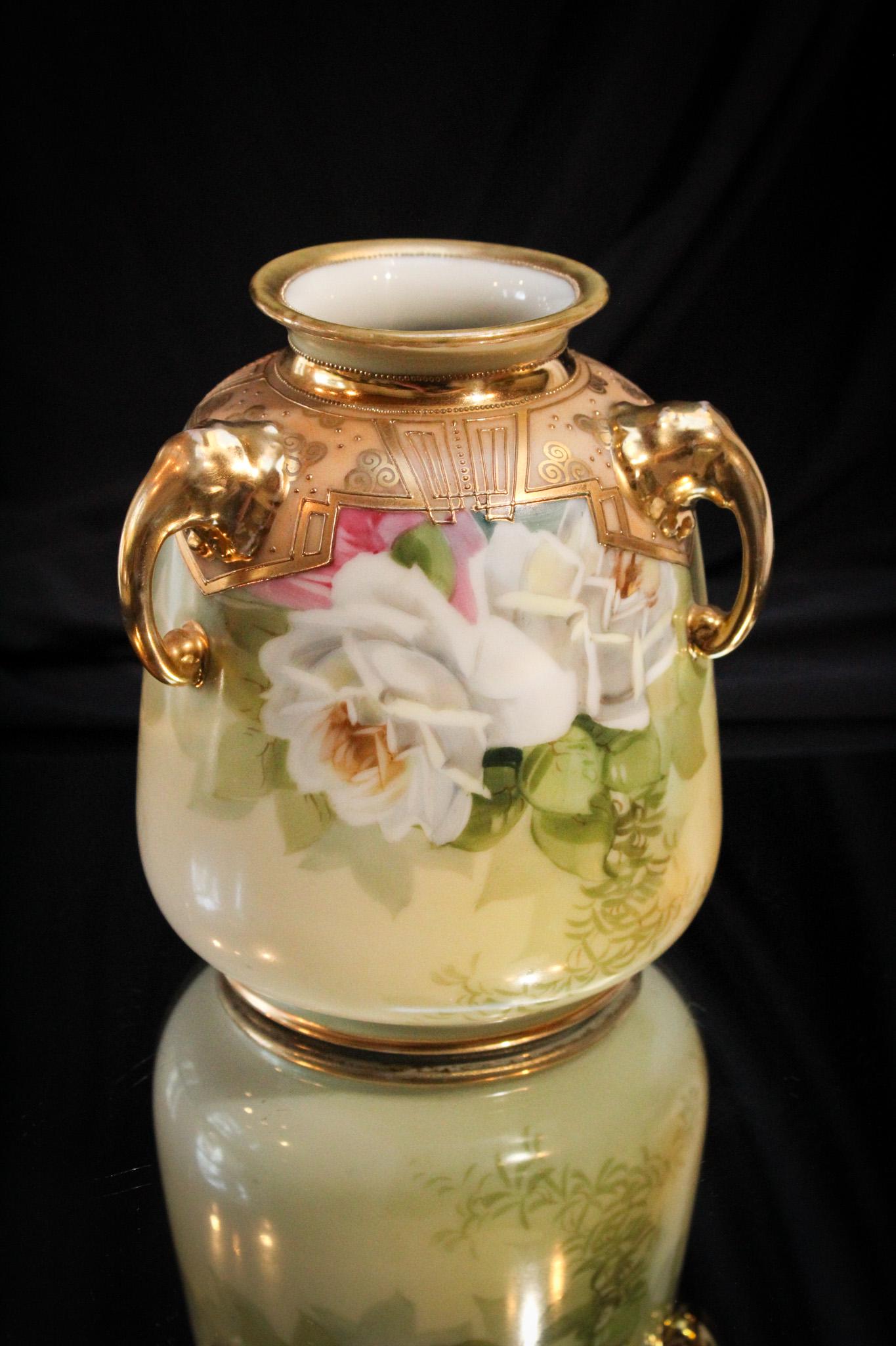 Nippon Elephant Handle Roses Vase: Charming Nippon elephant handle vase with rose deocration. Lots of gold on this one. Just a gorgeous little vase. It stands erect at 6".