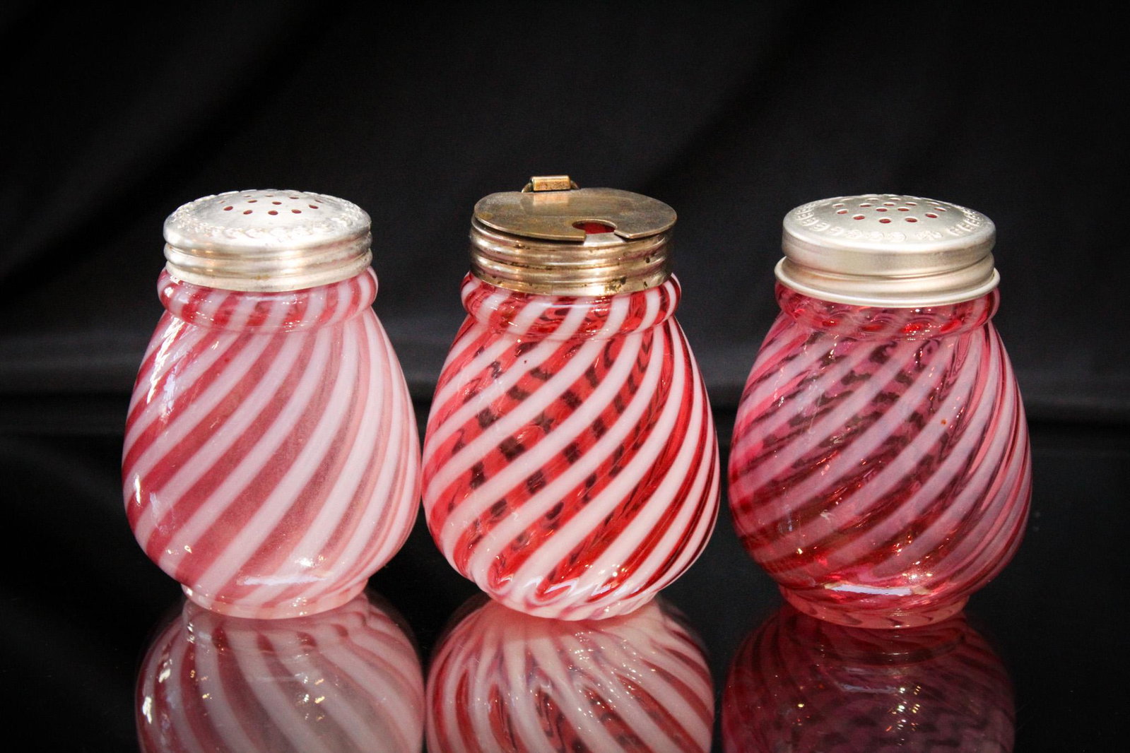 3 pc Lot Victorian Nickel Swirl Cranberry Opalescent Shakers & Mustard: One is tough. Two is really hard. Three at one time is impossible to find in this cranberry opalescent Nickle Swirl pattern pair of shakers and mustard jar. Super examples. Presented by, Magnum Auctio