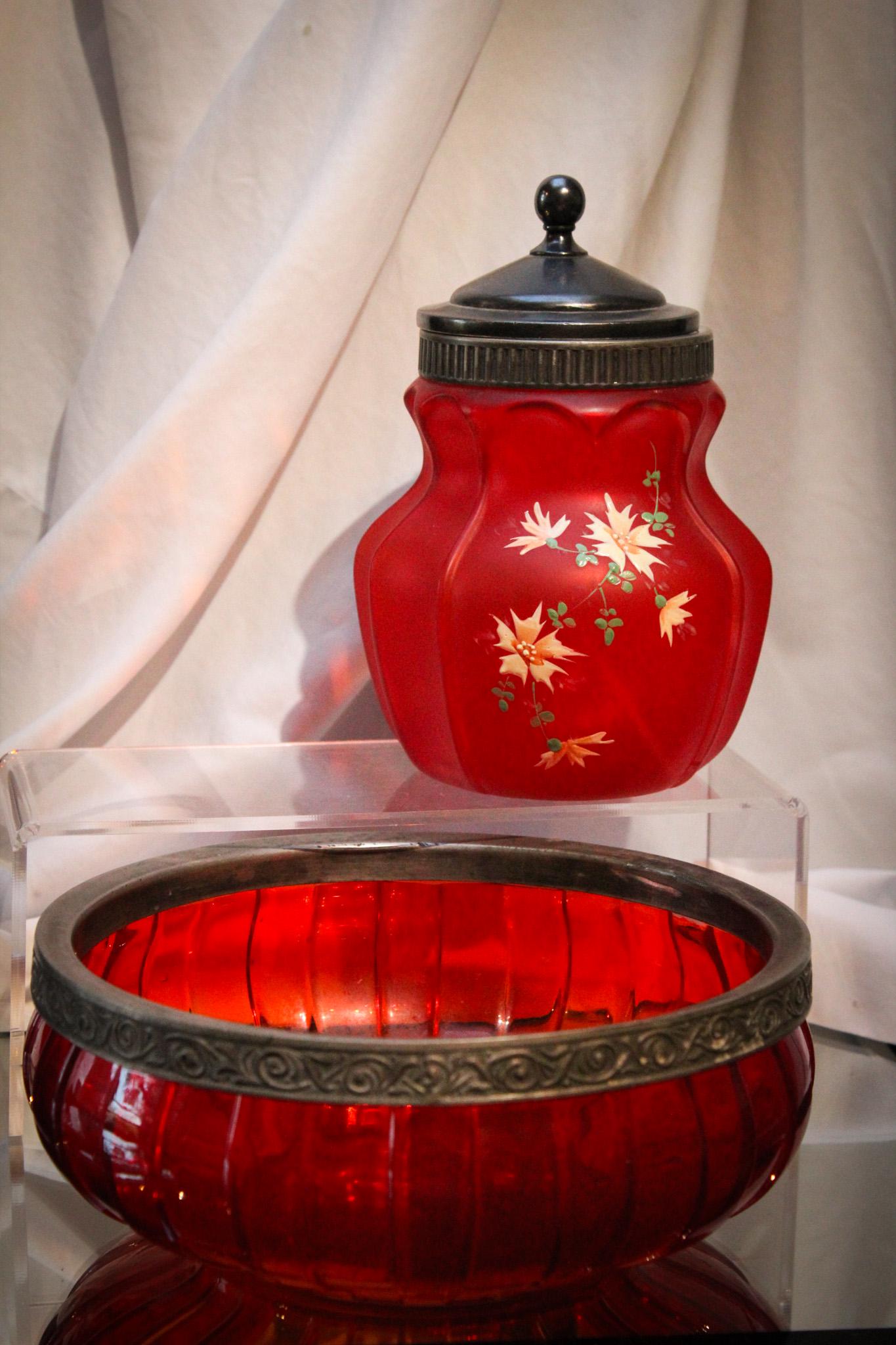 2 pc Lot Victorian Consolidated Pigeon Blood Satin Glass: Excellent pairing of two pieces of Consolidated victorian enameled glass in pigeon blood. A Torquay pattern bowl and an Open Heart Arches jar. Tallest measures 8" of pure fabulousness.