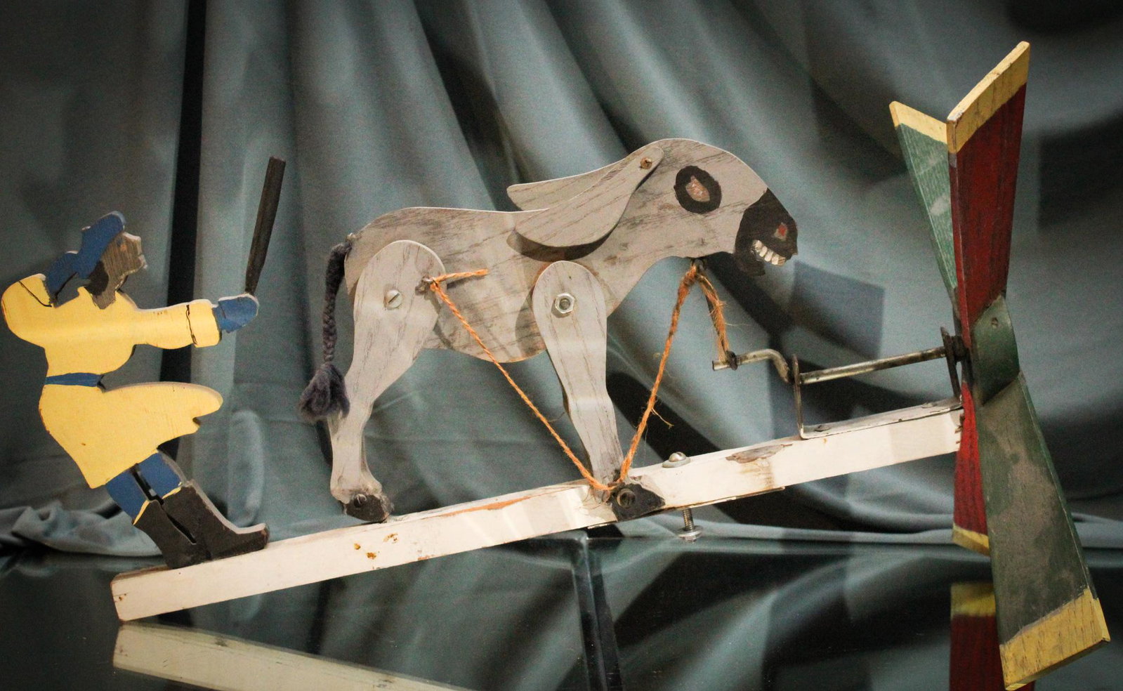 Folk Art Woman & Donkey Whirlygig: A woman and her favorite donkey Folk Art whirlygig. Measures 19" by 12".