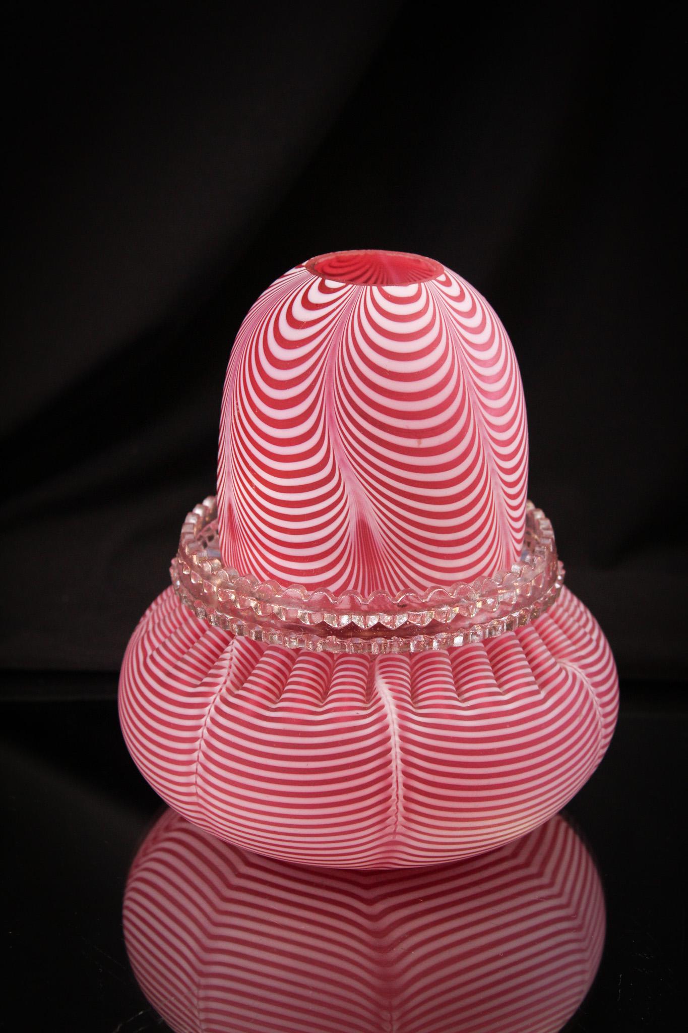 Cranberry Nailsea Victorian Fairy Lamp: Rich cranberry color and crisp thin white nailsea looping. Shade resides on a Clarke's candle cup. Measures 6" tall.