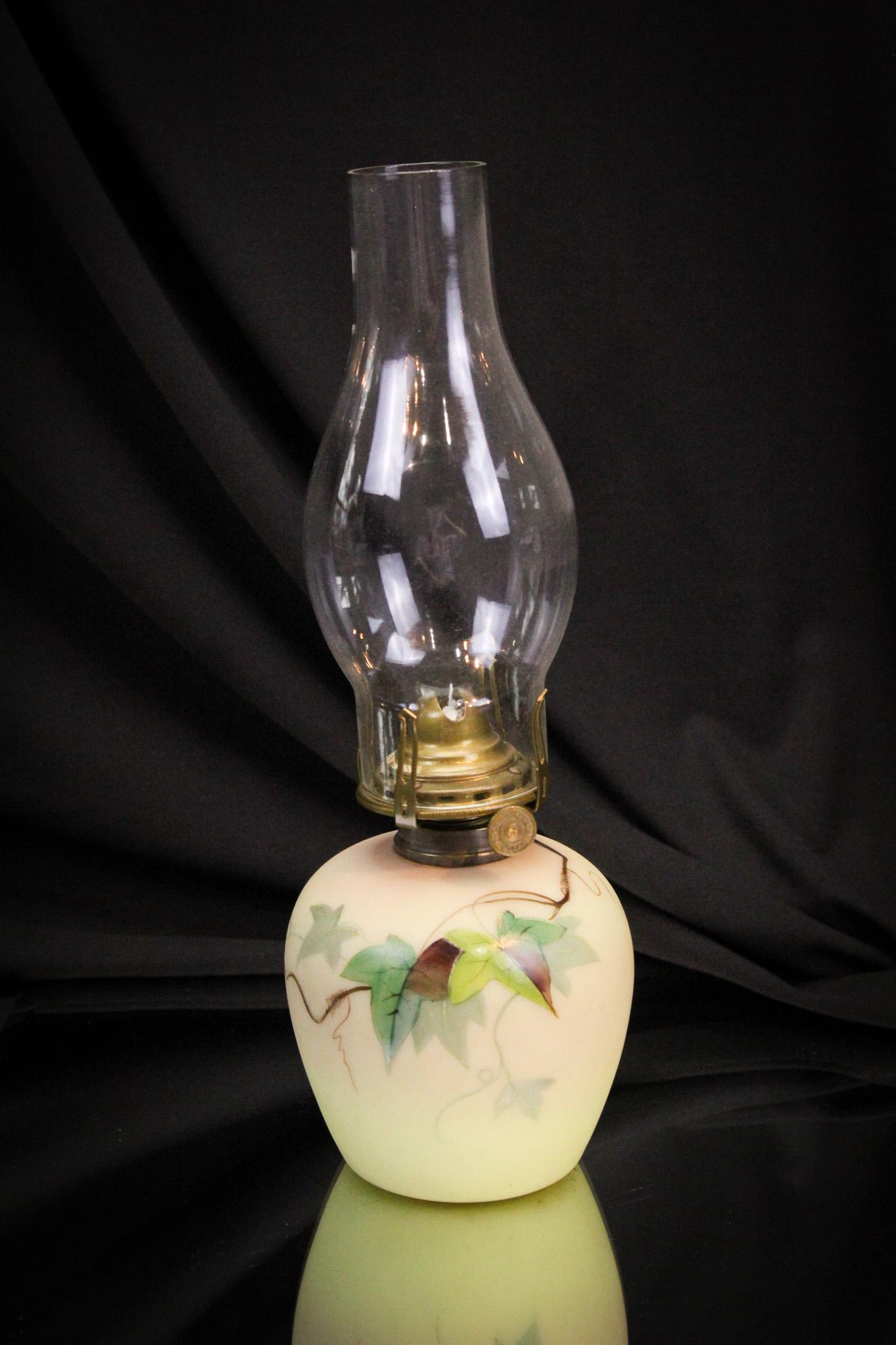 Webb Burmese Ivy DÃ©cor Victorian Oil Lamp: Beautiful shaded burmese coloring accents this lovely Victorian oil lamp and decoration of English ivy only adds to the drama of this rare piece. It measures a whopping 11" tall to the top of the chim