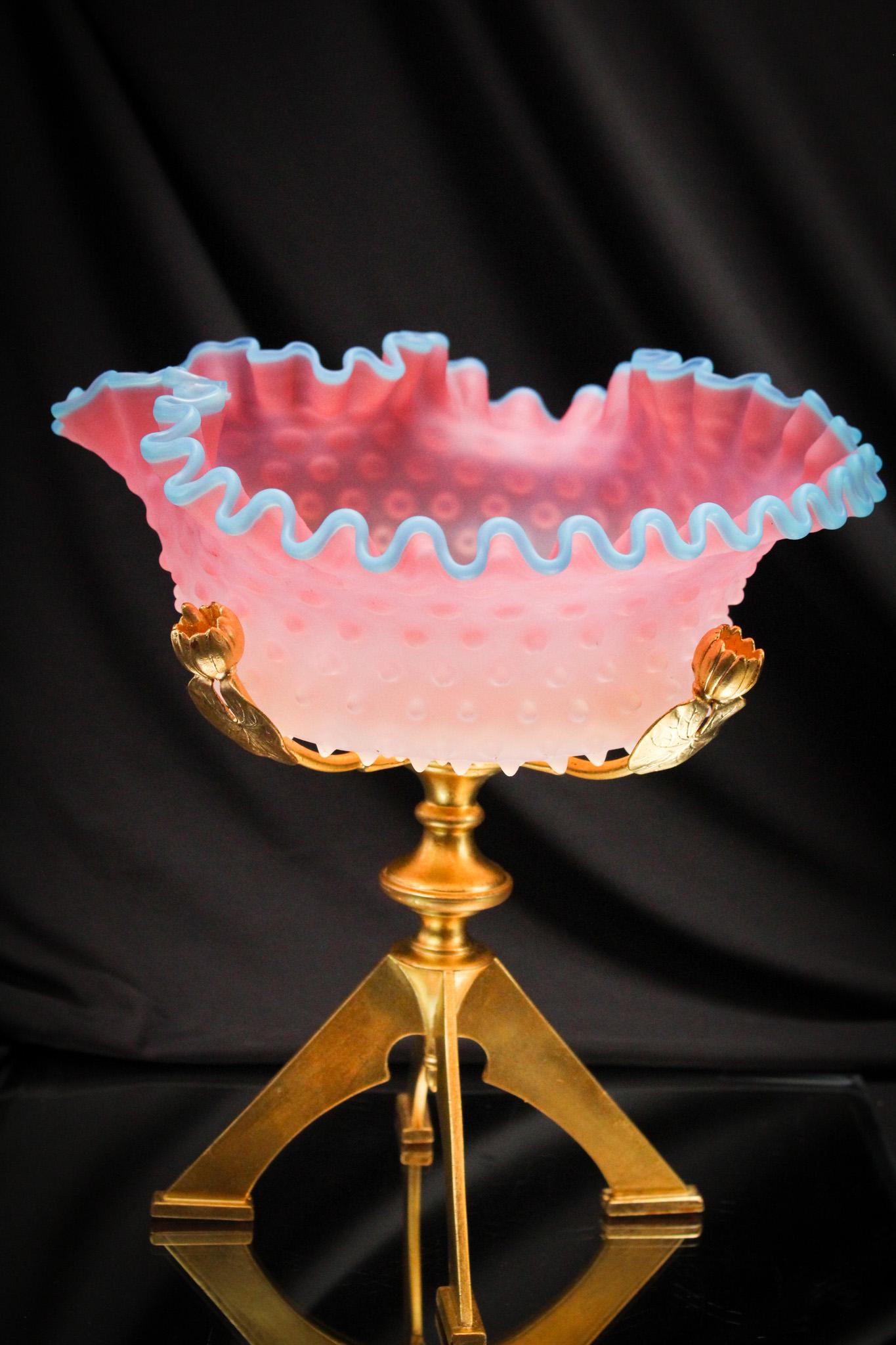Victorian Gilt Art Glass Hobnail Brides Basket Bowl Centerpiece: Striking gilt Victorian lotus embellished holder complete with original hobnail Victorian satin glass bowl with applied blue rim. Gorgeous! It stands 11" tall of pure heaven.