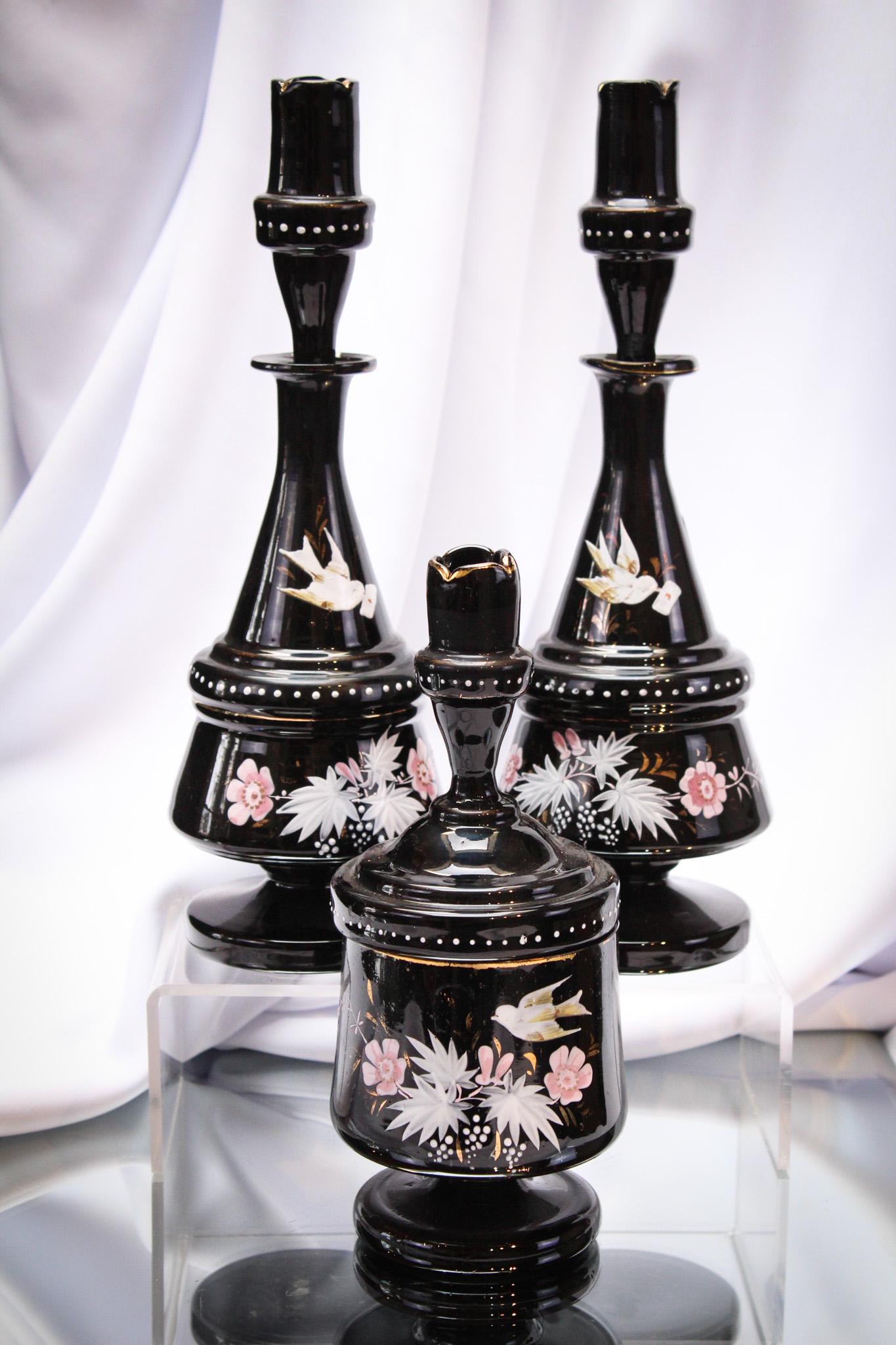 3 pc Victorian Black Enameled Glass Cologne Vanity Dresser Set: Gorgeous black glass enameled cologne bottle vantity dresser set. Lovely decoration of birds and flowers. Tallest measures 11 1/2" tall.