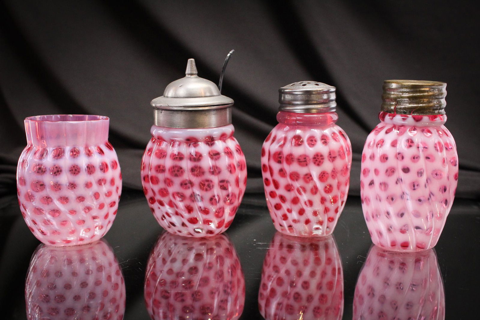 4 pc Lot Hobb's Cranberry Opalescent Windows Swirled Fineries: Nice assembly here of Hobb's famous Windows Swirled pattern in cranberry opalescent. These four include a toothpick holder, a mustard jar, and a pair of shakers. Tallest measures 3 1/2".