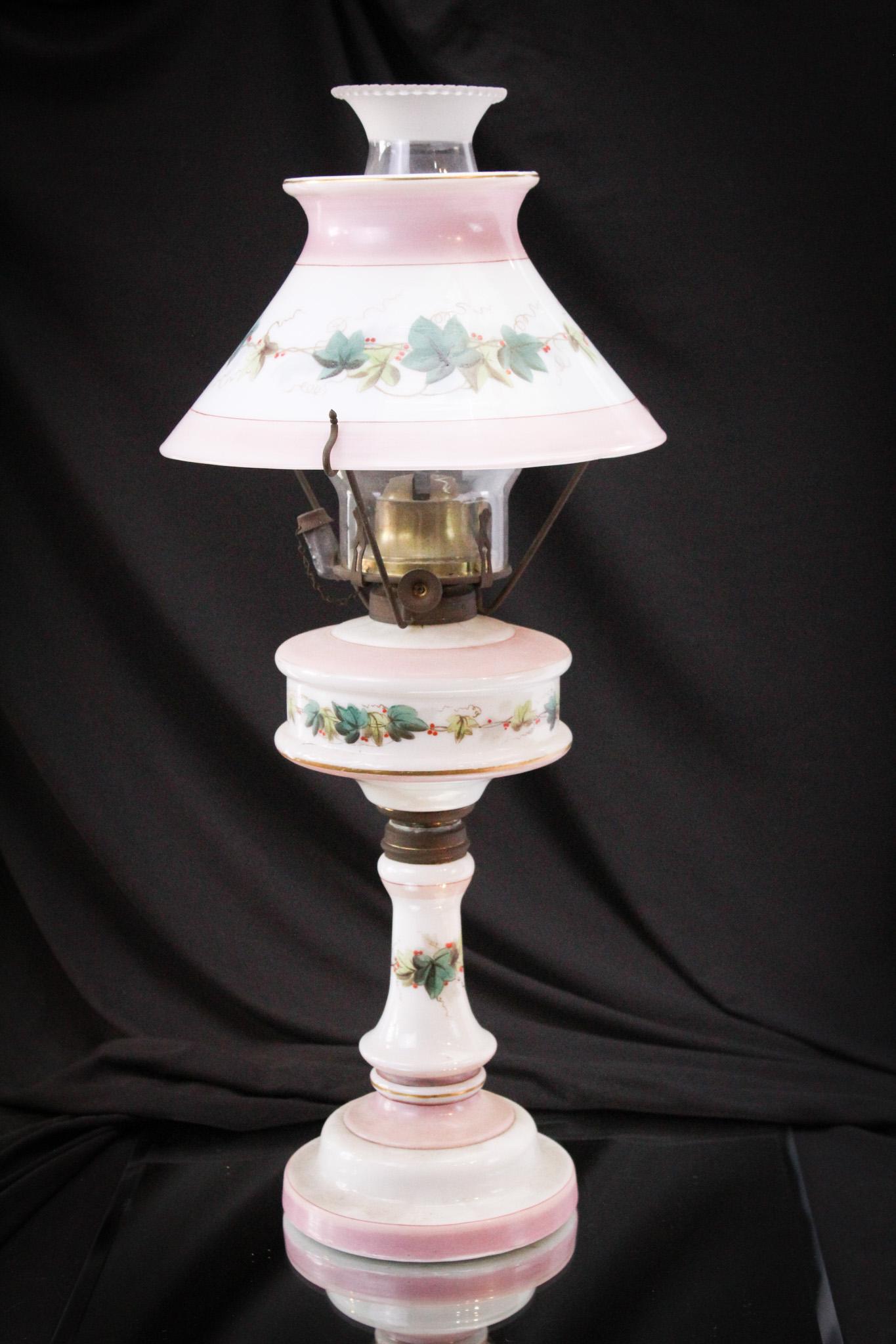 Victorian Ivy & Berry Decorated Oil Parlor Lamp: Complete and original ivy and berry enameled decoration completes this phenomel oil lamp. What a find and to have it untouched as this, what a thrill! It stands a prominent 20" tall.