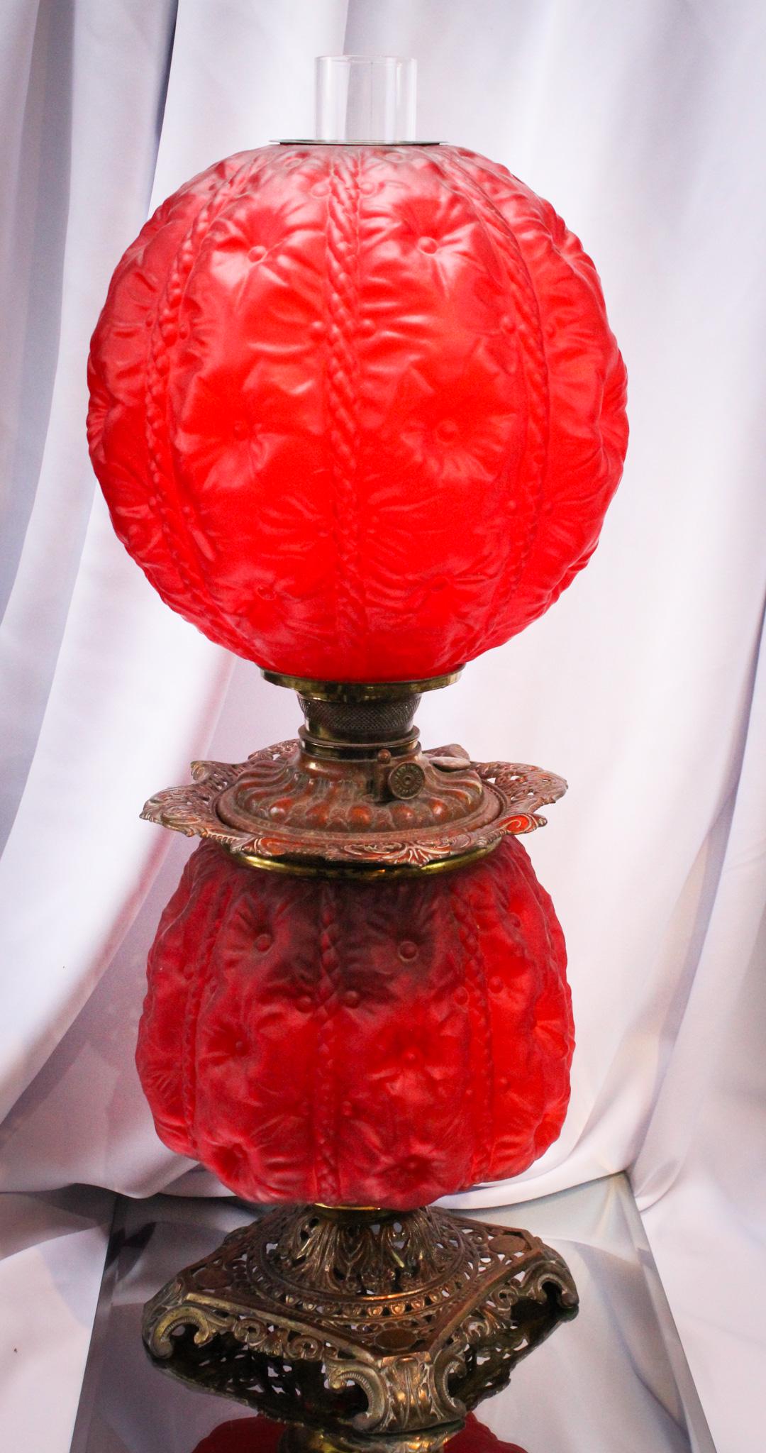 Red Satin Hollyhock Victorian Gone with the Wind Lamp: Rich velvety red satin glass makes up this beautiful Victorian parlor lamp. The pattern is Hollyhock named after the mid summer flower. A real showstopper. It stands 26" tall.
