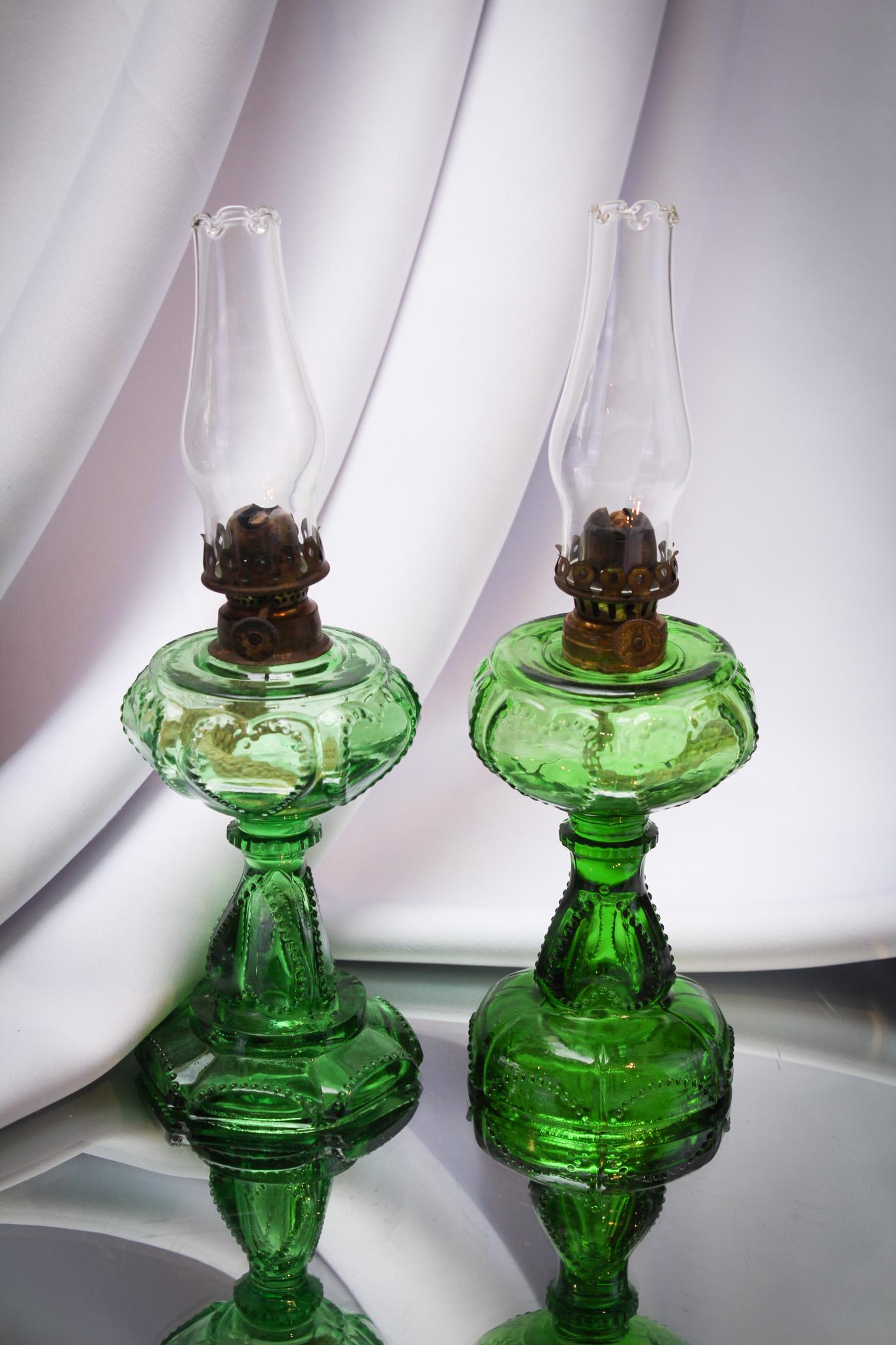 2 pc Lot Victorian Sweetheart Miniature Oil Lamps 1 Unusual: Select offering of two Victorian green sweetheart oil lamps. Note the unusual base on the one. Nice lamps with complete old burnesers and chimneys. Tallest measures 5".