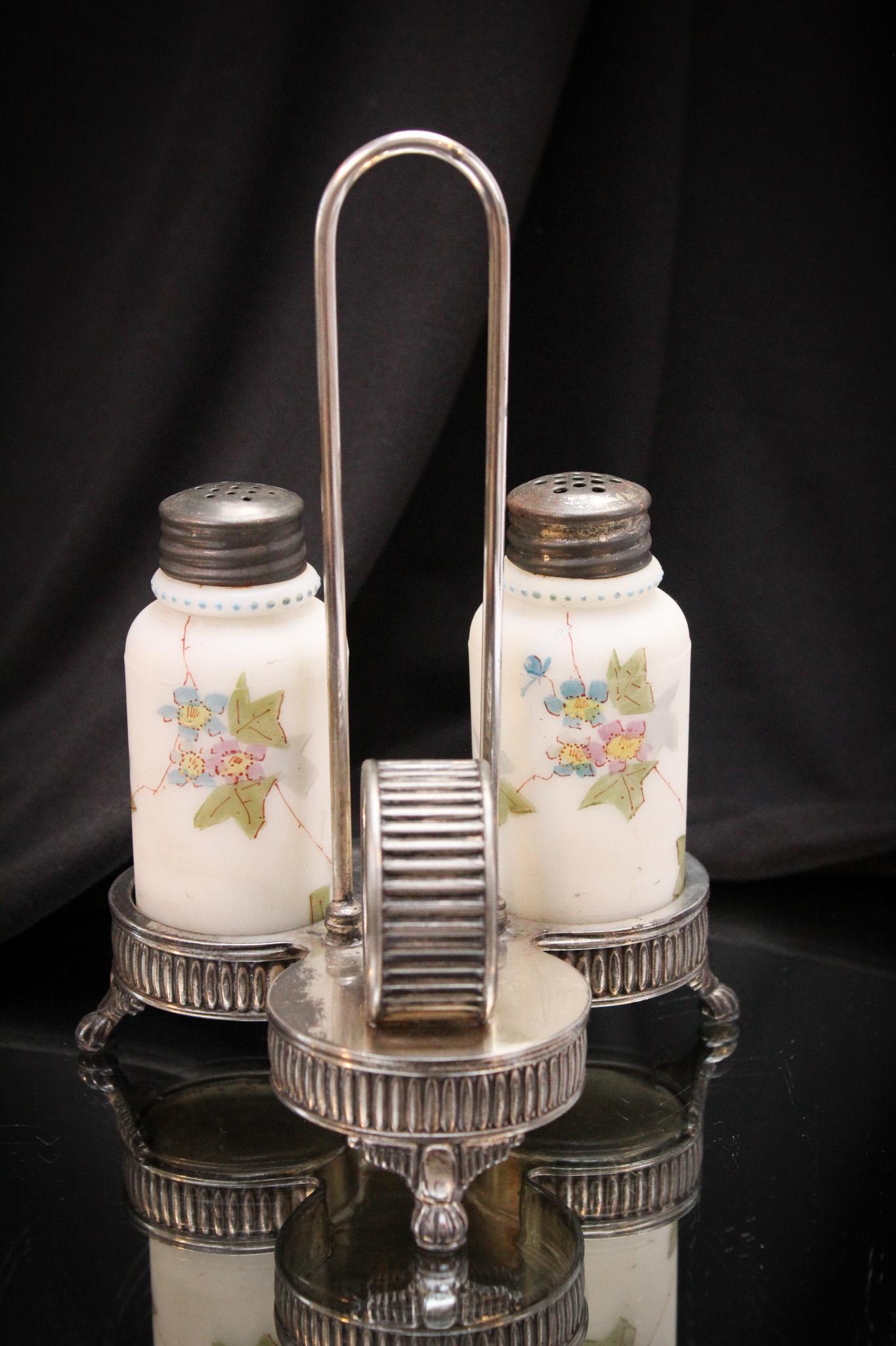Wilcox Victorian Silverplate Salt Shaker s & Holder: Nice pair of cylinder shakers in a signed Wilcox silverplate castor frame complete with napkin ring. Very nice! It measures 7" tall.