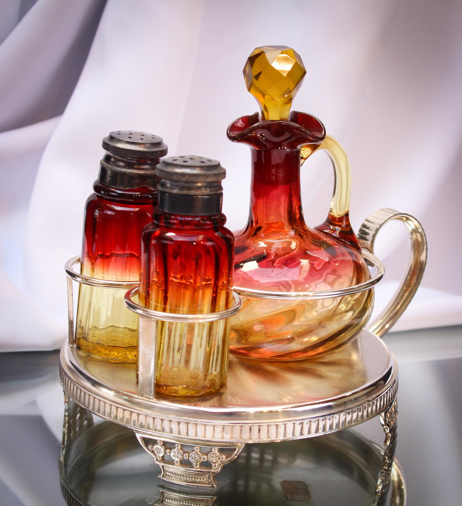 Derby Silverplate Victorian Amberina Cruet Shaker Set: Beautiful and rich in coloring best describes this lovely castor set. Swirl cruet and rib optic shakers are set in a signed Derby Silverplate frame. Nice! It stands a large 7 1/2" tall.