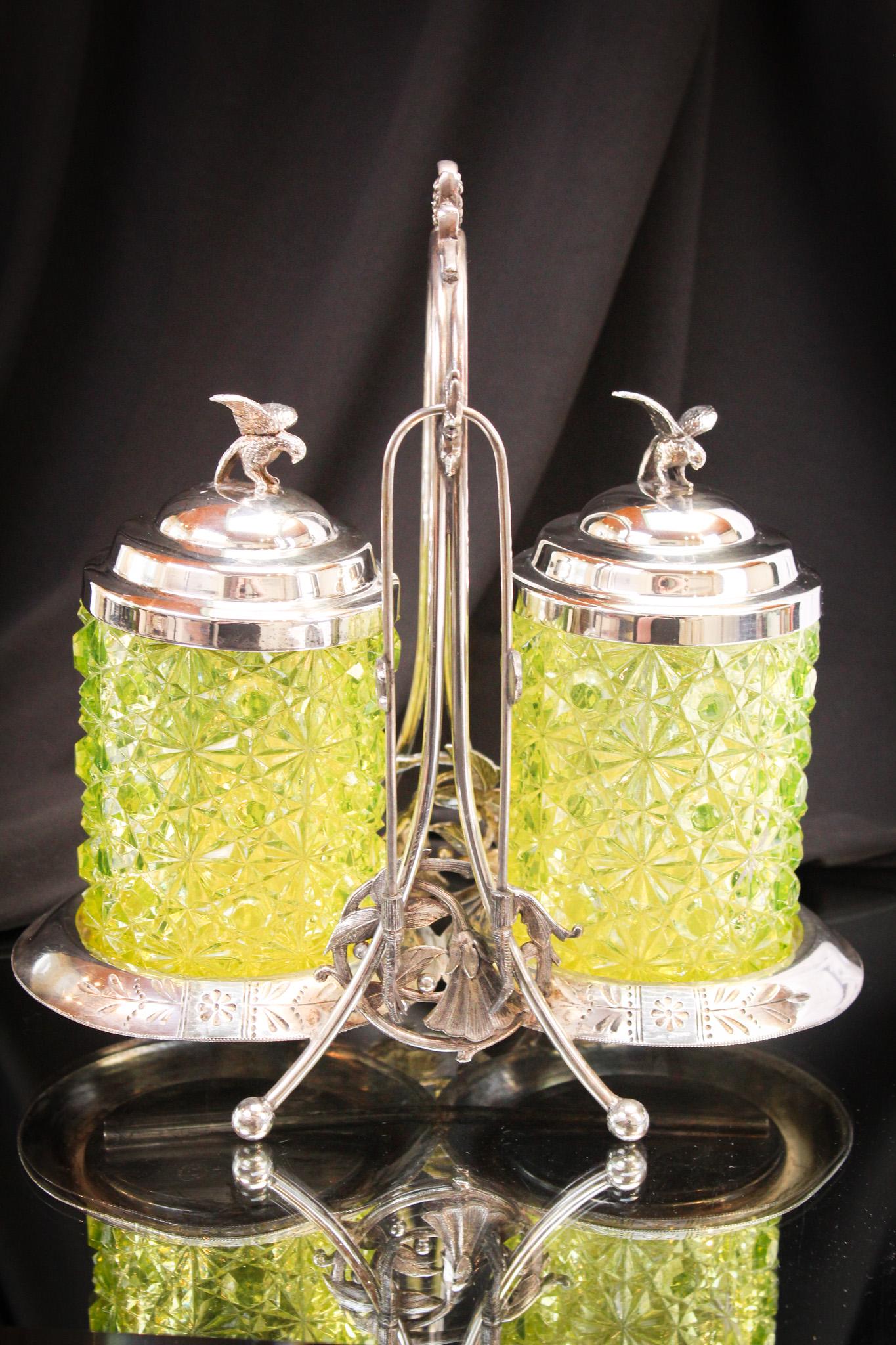 Meriden Silverplate Vaseline Daisy & Button Double Pickle Castor: Vasies unite for this super example of a double Victorian pickle castor in vaseline glass completed by daisy and button inserts. It measures 10" tall.