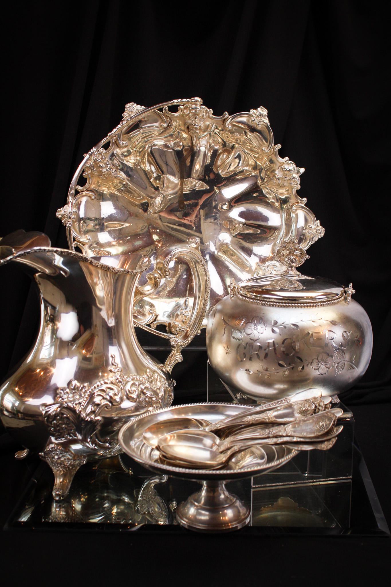 23 pc Lot Silverplate & Sterling: Super 23-piece lot of silverplate and sterling fineries comprised of a hand chased pitcher, cracker jar, spoons and sterling dish. Tallest measures 9 1/2".
