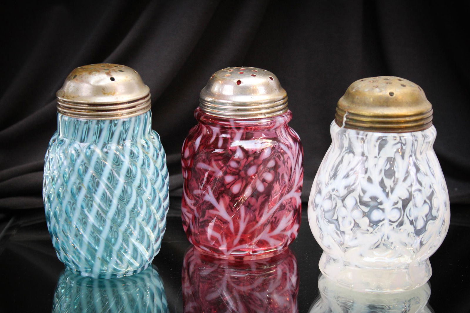 3 pc Lot Victorian Opalescent Glass Sugar Shakers: Here's a trio of some fancy table accessories of the Victorian era. Three nice and oh so pretty sugar shakers in various patterns: One blue Reverse Swirl, one white opal Spanish Lace, and one cranberr