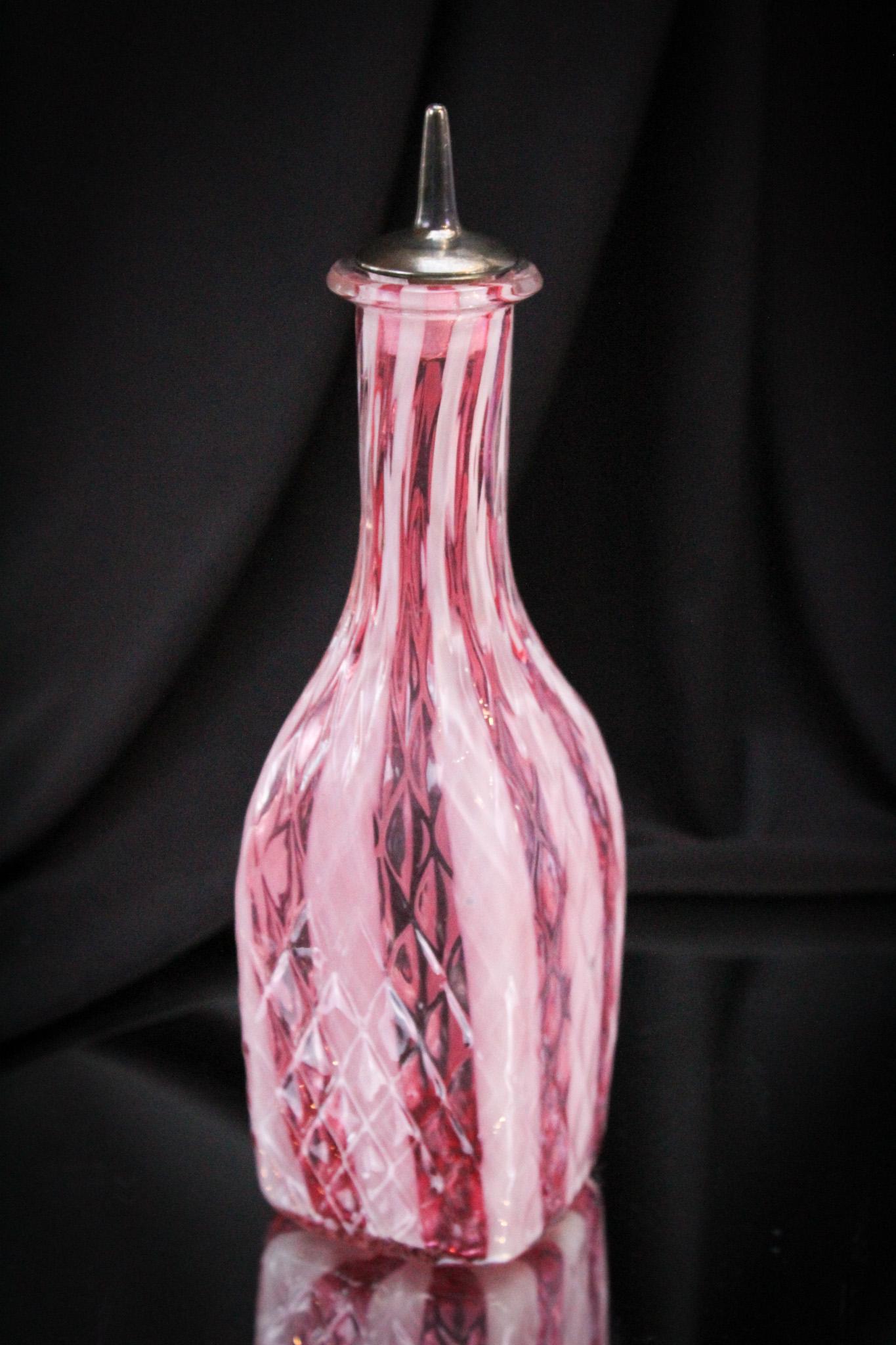Cranberry Diamond Quilt Wide Stripe Victorian Barber Bottle: Another fine offering in our line up of Victorian cranberry diamond quilt wide stripe glass. This bottle is square in form. It stands a tall 8".