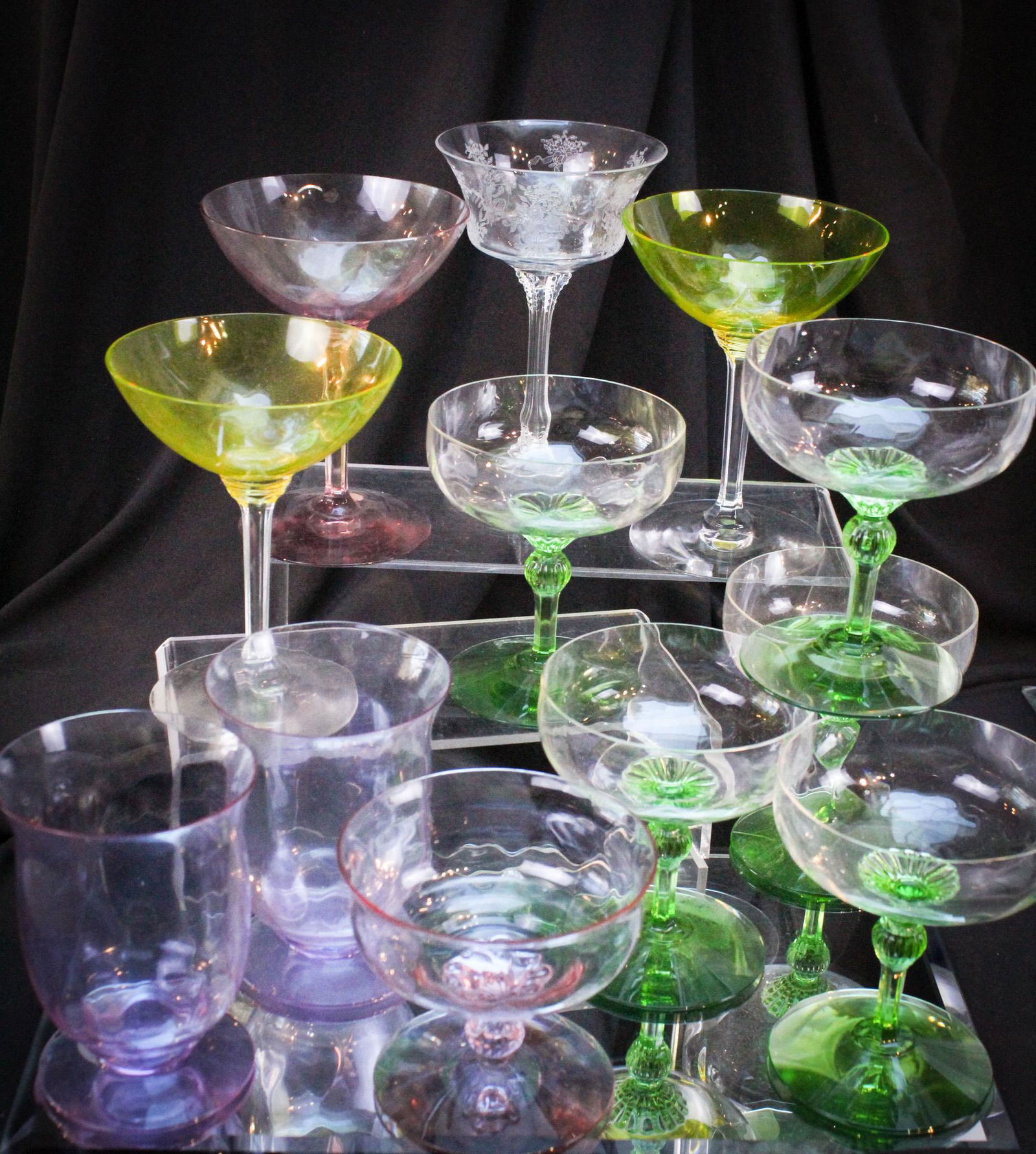 12 pc Lot Heisey Glass Stems Alexandrite Moongleam & More: Wonderful family gathering of Heisey glass comprised of Alexandrite, Moongleam, and more. Twelve stems in all. Tallest measures 6".