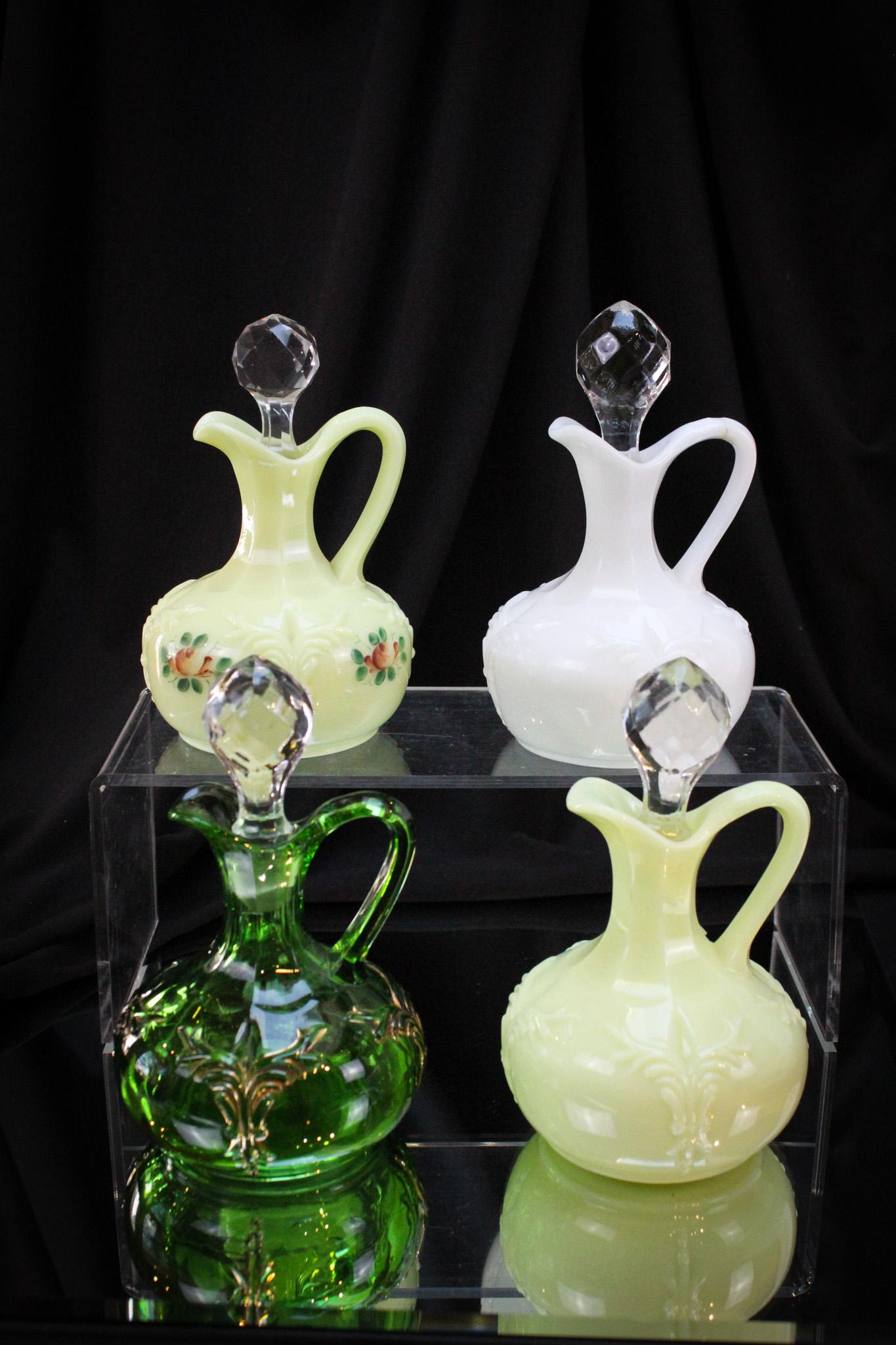 Heisey Glass 4 pc Lot Winged Scroll Cruets: Always a collector favorite. Here are four prime examples of the Winged Scroll pattern in milk glass and custard.