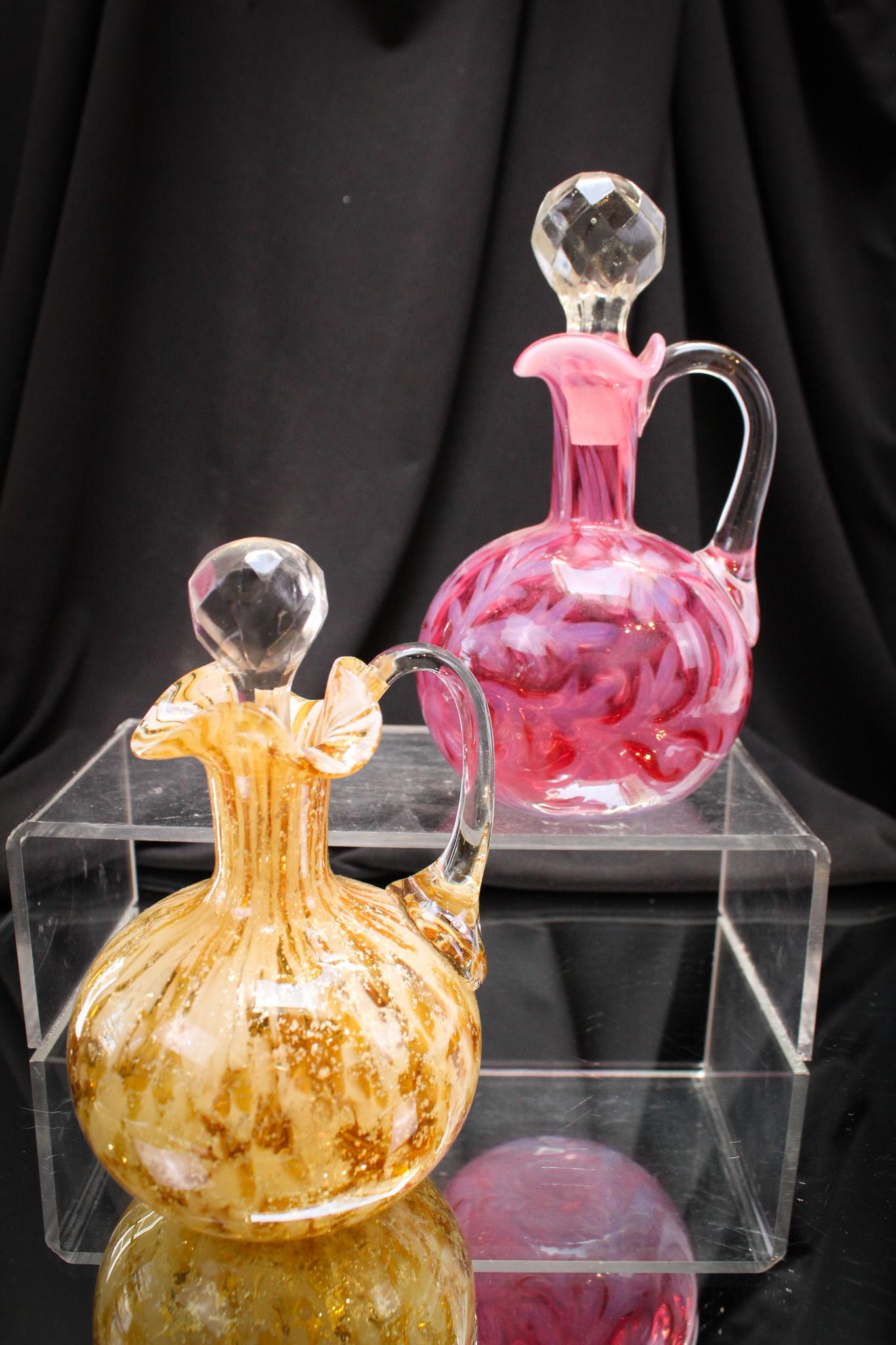 2 pc Lot Cranberry Opalescent & Mica Spatter Cruets: Fine examples of cruets here, folks. One cranberry opalescent ball shaped Daisy and Fern and the other is attributed to Phoenix glass. It is amber with mica and spatter inclusions. Beautiful cruets. T