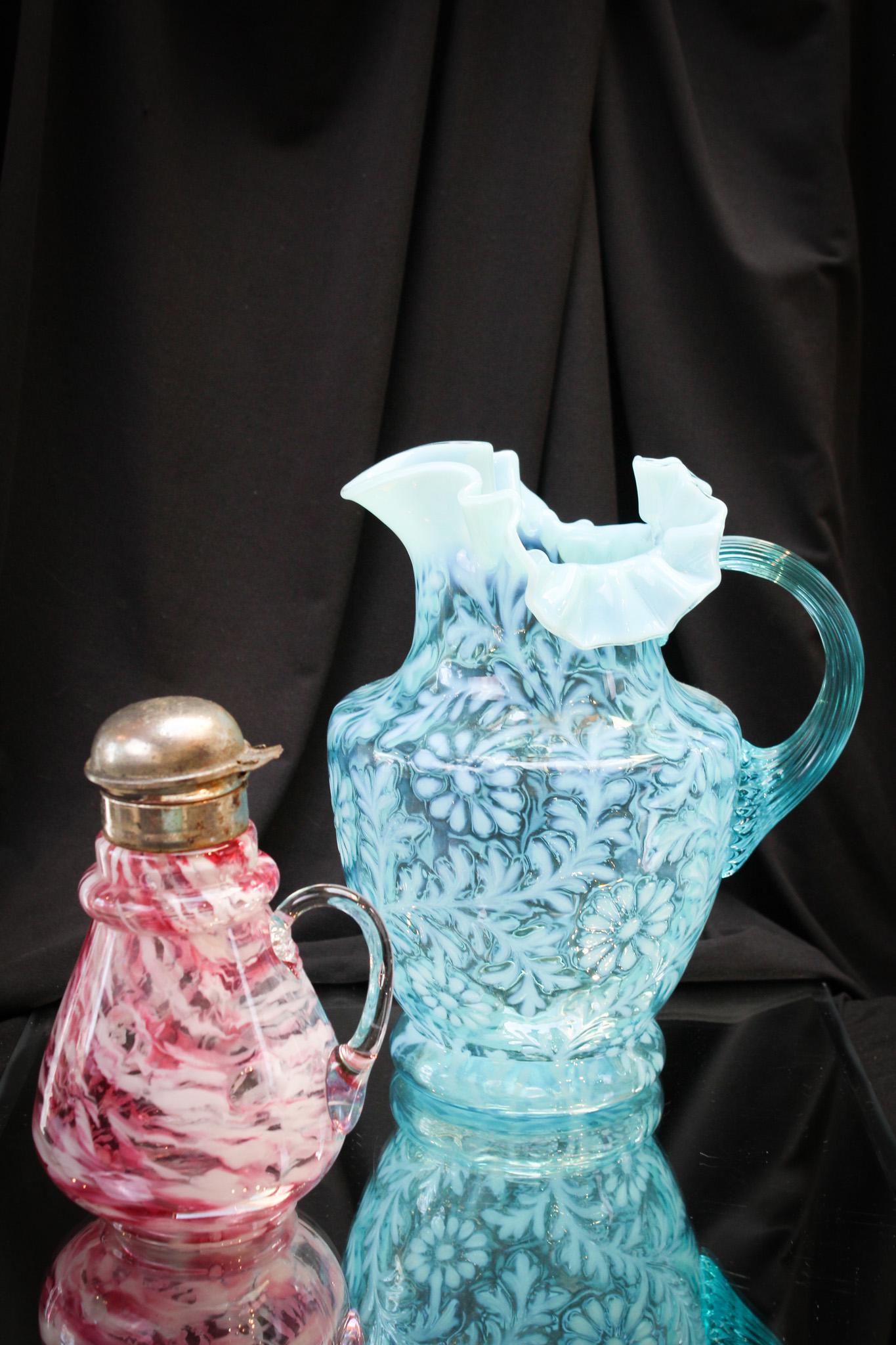 2 pc Lot Victorian Opalescent Glass & More: Two fine pieces of glass from the gilded age: A blue opalescent Daisy and Fern pitcher and a syrup pitcher. Tallest measures 9 1/2".