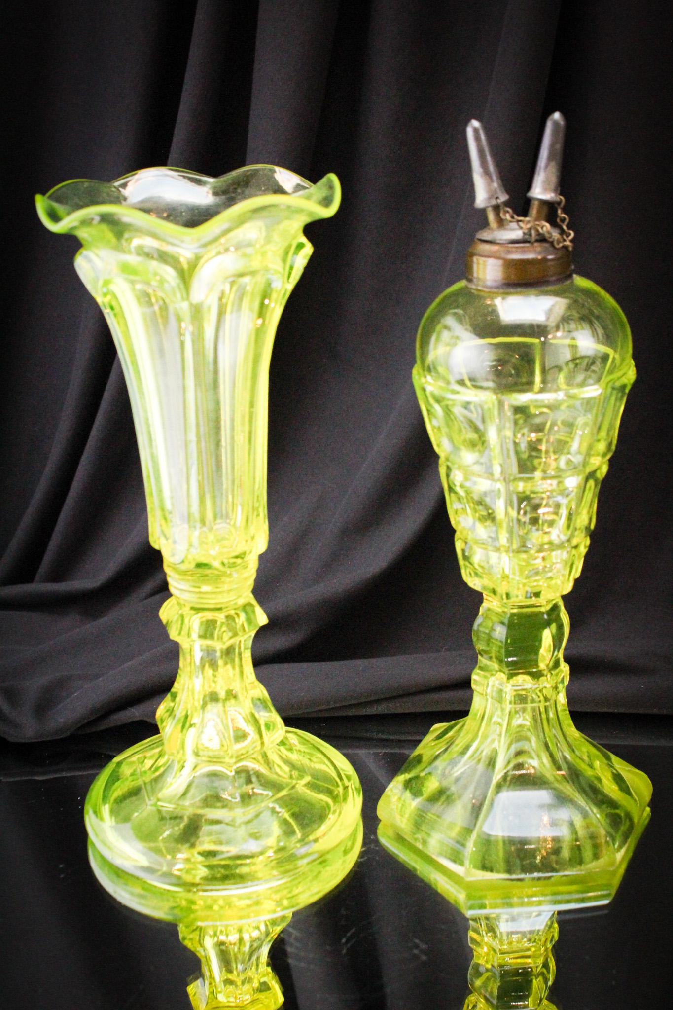 2 pc Lot Early Vaseline Flint Vase and Oil Lamp: Two fine pieces of early vaseline flint glass comprised of an oil lamp and a vase. Tallest measures 10 1/2".