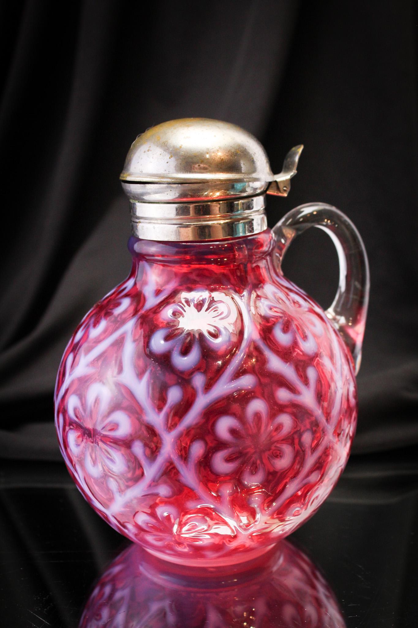 Rare Cranberry Opalescent Daisy In Criss Cross Victorian Syrup Pitcher: It doesn't get any better than this one! Superb example of the Daisy in Criss Cross pattern in a syrup pitcher. Great coloring and opalescence! It stands 6" tall.