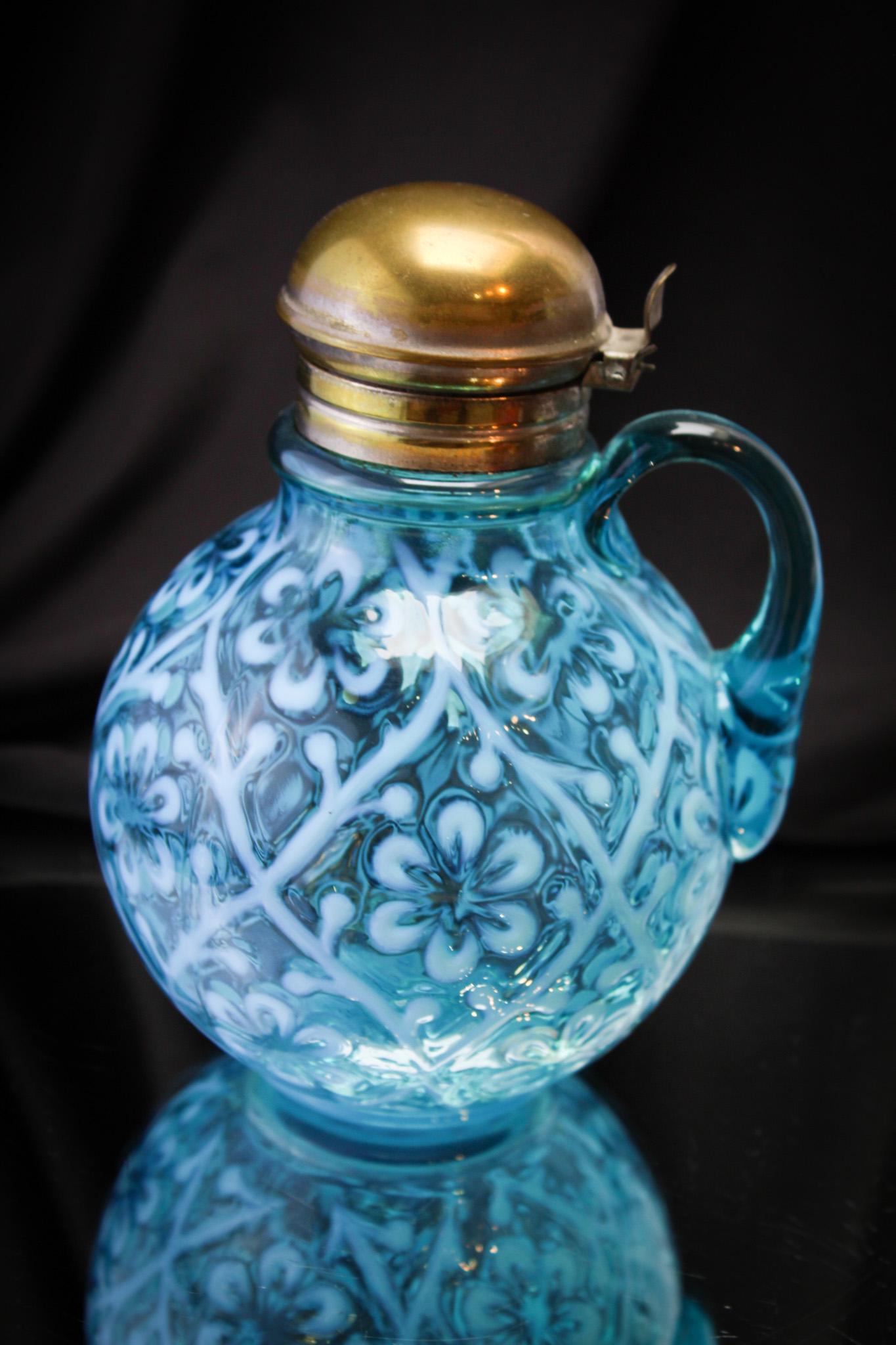 Blue Opalescent Diasy In Criss Cross Victorian Syrup Pitcher: Beautiful blue opal example of the Daisy in Criss Cross pattern in a syrup pitcher. Complete and original, it stands 6" tall.