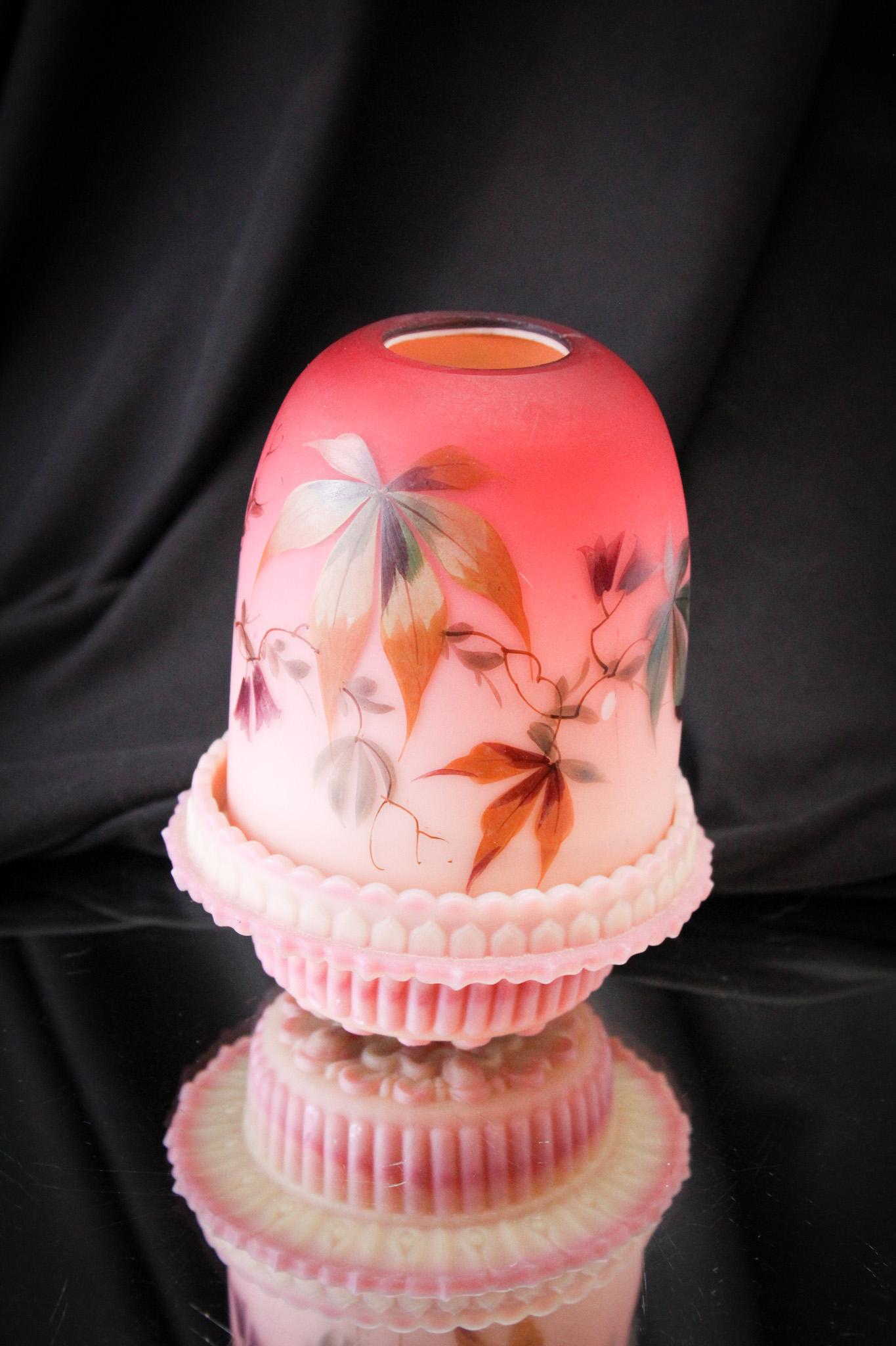 Peachblow Victorian Decorated Fairy Lamp: Gorgeous coloring dominates this ultra-attractive fairy lamp with enameled decoration on the shade and matching coloring burmese Clarke's candle cup base. Scrumptious. It measures 5" tall.