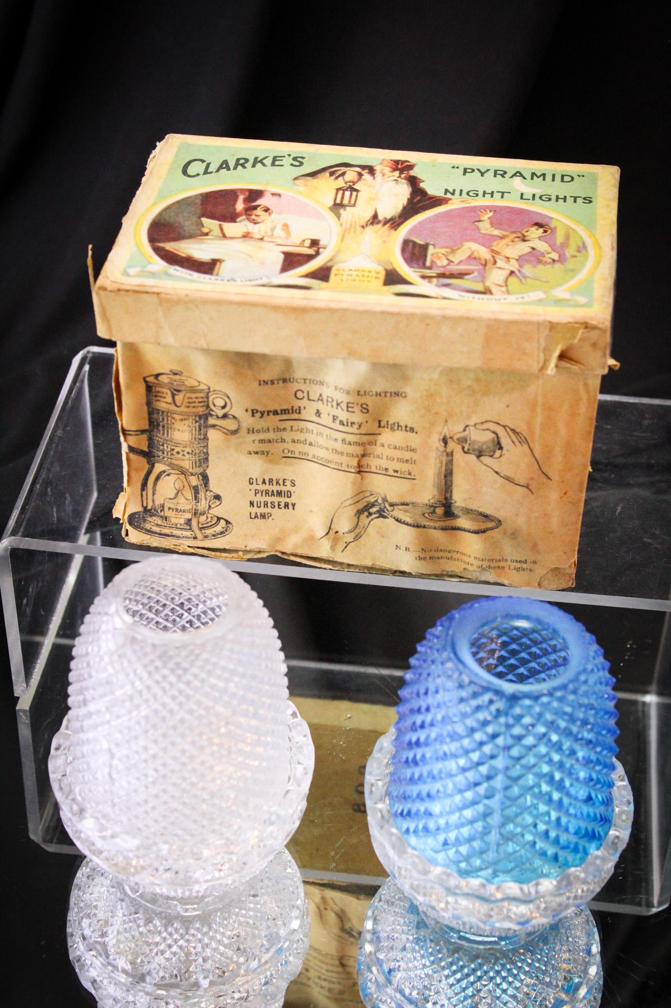 Original Box of 12 Clarke's Fairy Lamps Candles & Two Lamps: Nice old stock in this original Clarke's fairy lamp candles. Twelve in all. These combine along with two miniature fairy lamps in the Diamond Point pattern: One clear and one blue. Tallest measures 3 