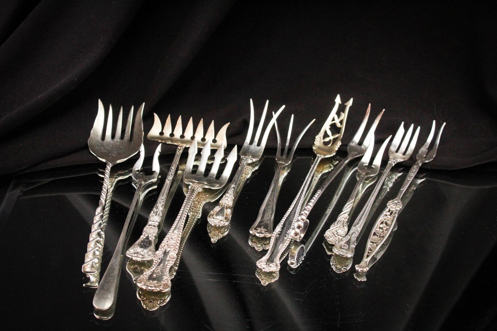 11 pc Lot Sterling Silver Forks: Nice assortment of sterling silver forks in various makers and forms. Longest measures 6 1/2". Weighs 5.353 OZT