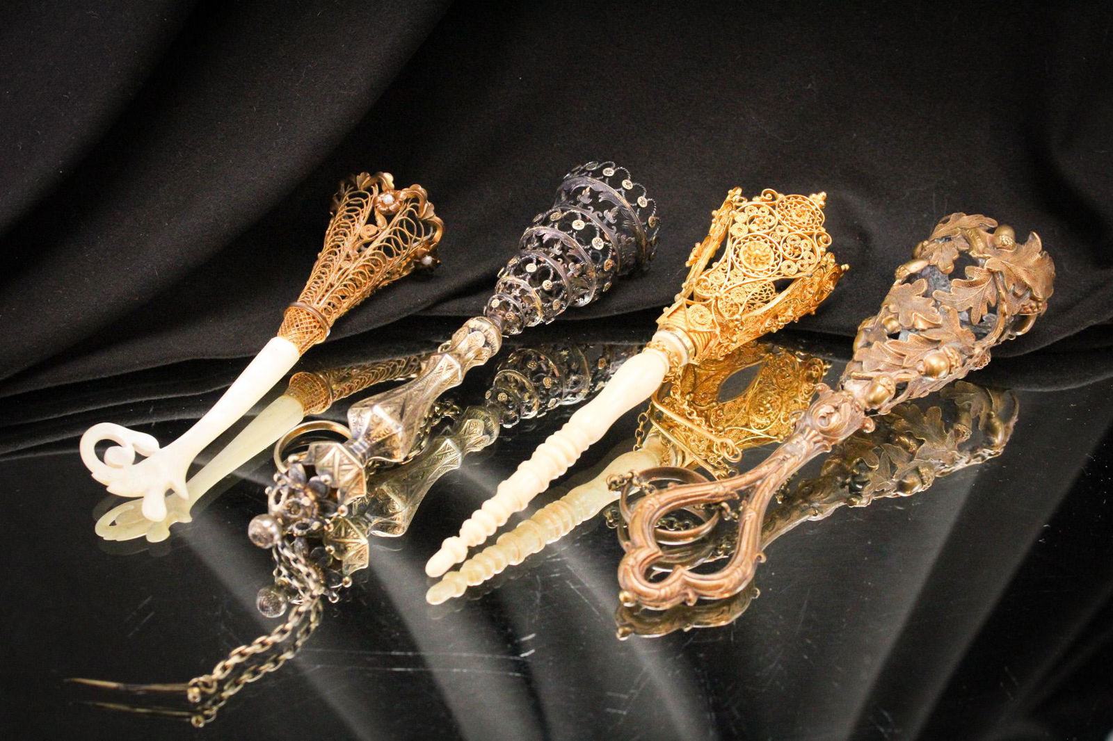 4 pc Lot Victorian Antique Tussy Mussy Bouquet Holders: Fine offering of four antique tussy mussy bouquet holders. Nice assortment comprised of gilt filigree, mother of pearl, sterling, and more. Longest measures 6".