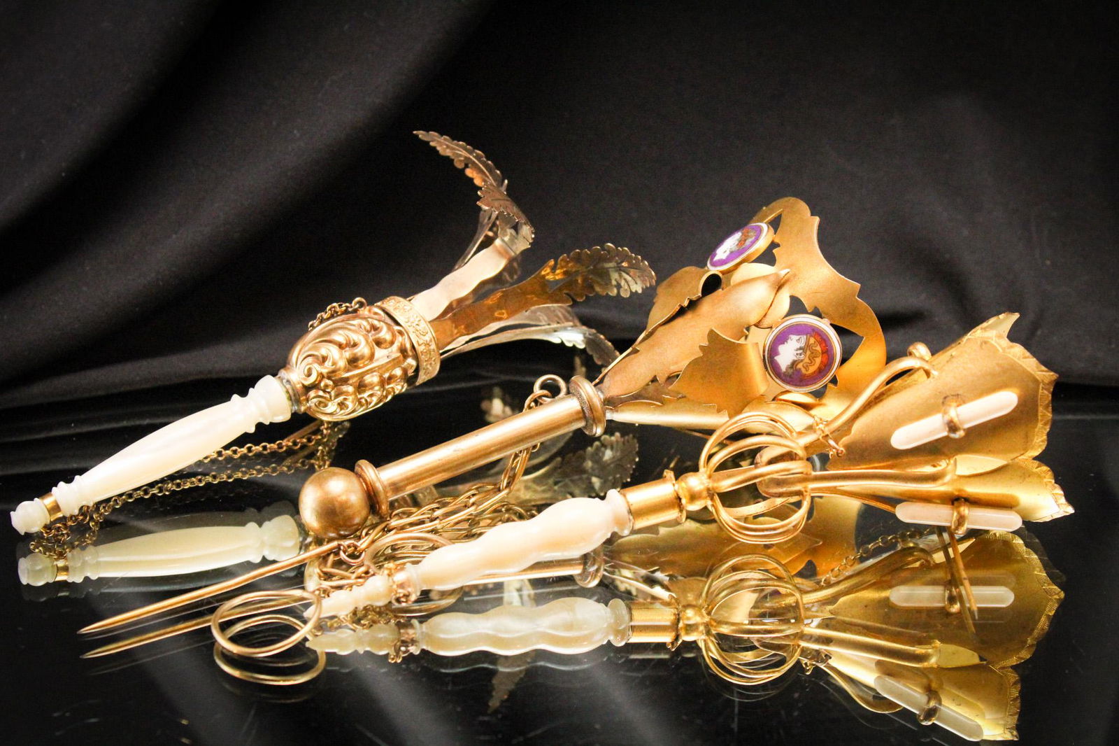 3 pc Lot Victorian Antique Tussy Mussy Bouquet Holders: Three selections offered together of Victorian antique tussy mussy bouquet holders. Two with mother of pearl handles and one with cameo embellishment. Longest measures 6 1/2".