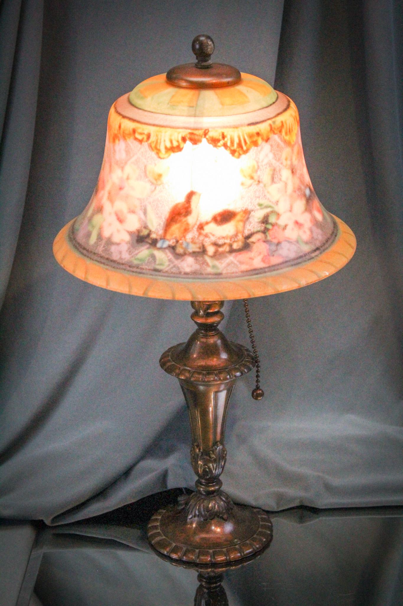 Pairpoint Boudoir Reverse Painted Table Lamp: Beautiful little signed Pairpoint shade and base boudoir lamp. Shade is decorated with birds and blossoming branches. Shade measures 8" diameter and lamp complete measures 15" tall.
