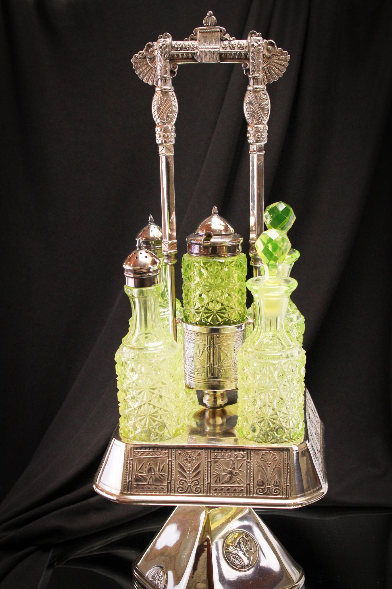 Signed Pairpoint Victorian Silverplate Vaseline Daisy & Button 5 pc Castor set: Gorgeous frame signed Pairpoint silverplate sets this set up a couple of notches. Very ornate. Beautiful set of five vaseline Daisy & Button pattern bottles complete this extravaganza of Victorian spl