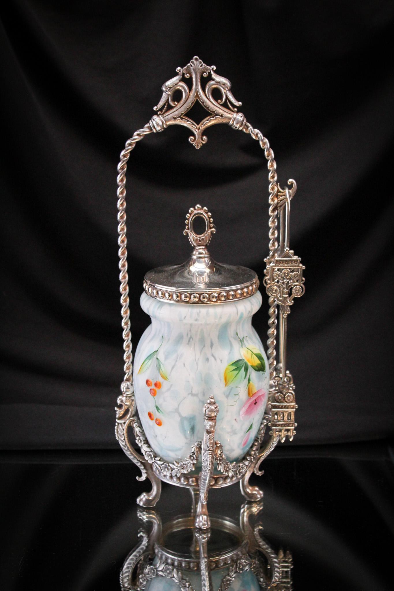 Tufts Silverplate Blue Spatter Satin Glass Enameled Victorian Pickle Castor: Fine example of a signed James Tufts silverplate Victorian castor frame complete with blue satin spatter enameled with florals glass insert. Complete with tongs and original matching lid. It stands 12