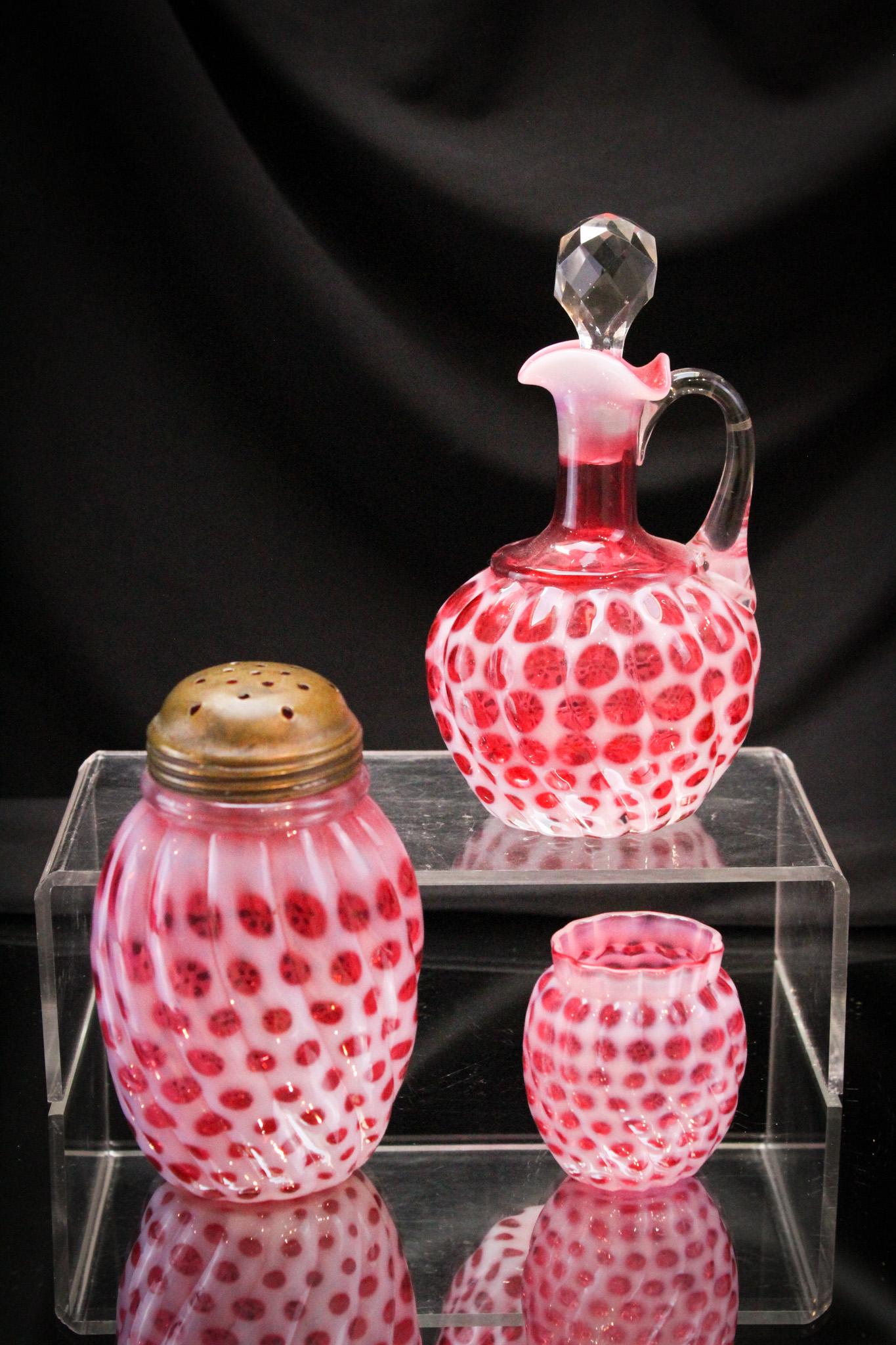 3 pc Lot Hobb's Cranberry Opalescent Toothpick Cruet Sugar Shaker: Select offering of three fine pieces of Hobb's glass in the Windows Swirled pattern: A sugar shaker, a cruet, and a toothpick holder. Tallest measures 6 1/2".