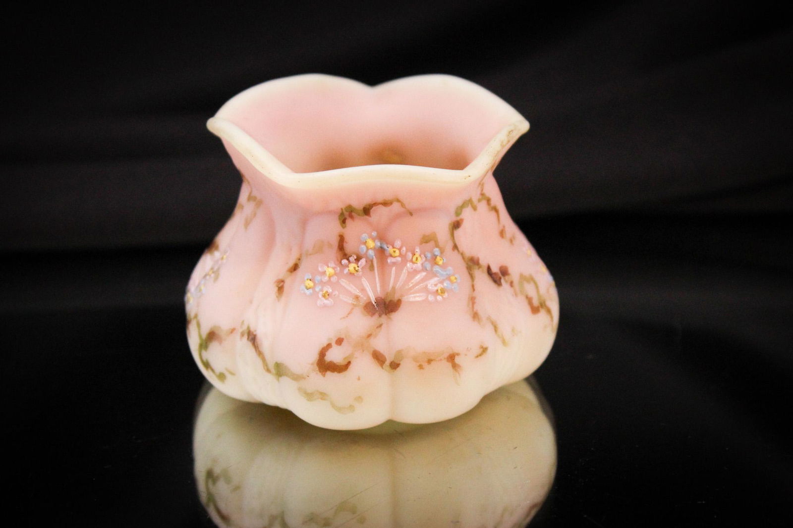 Mt. Washington Burmese Fig Mold Victorian Toothpick Holder: Great example of the wares Mt. Washington glass made. This little gem is in burmese glass complimented by floral decoration. It measures 1 3/4" tall.