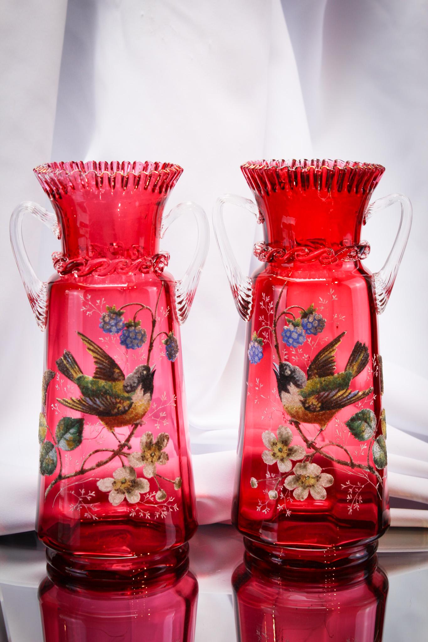 Fantastic Pr Cranberry Coralene Decorated Victorian Glass Opposing Vases: Over-the-top wonderful. This pair of cranberry Bohemian vases is an opposing pair with the best coralene decoration of birds, flowers, and berries. Each vase is complimented with handles. Each measure