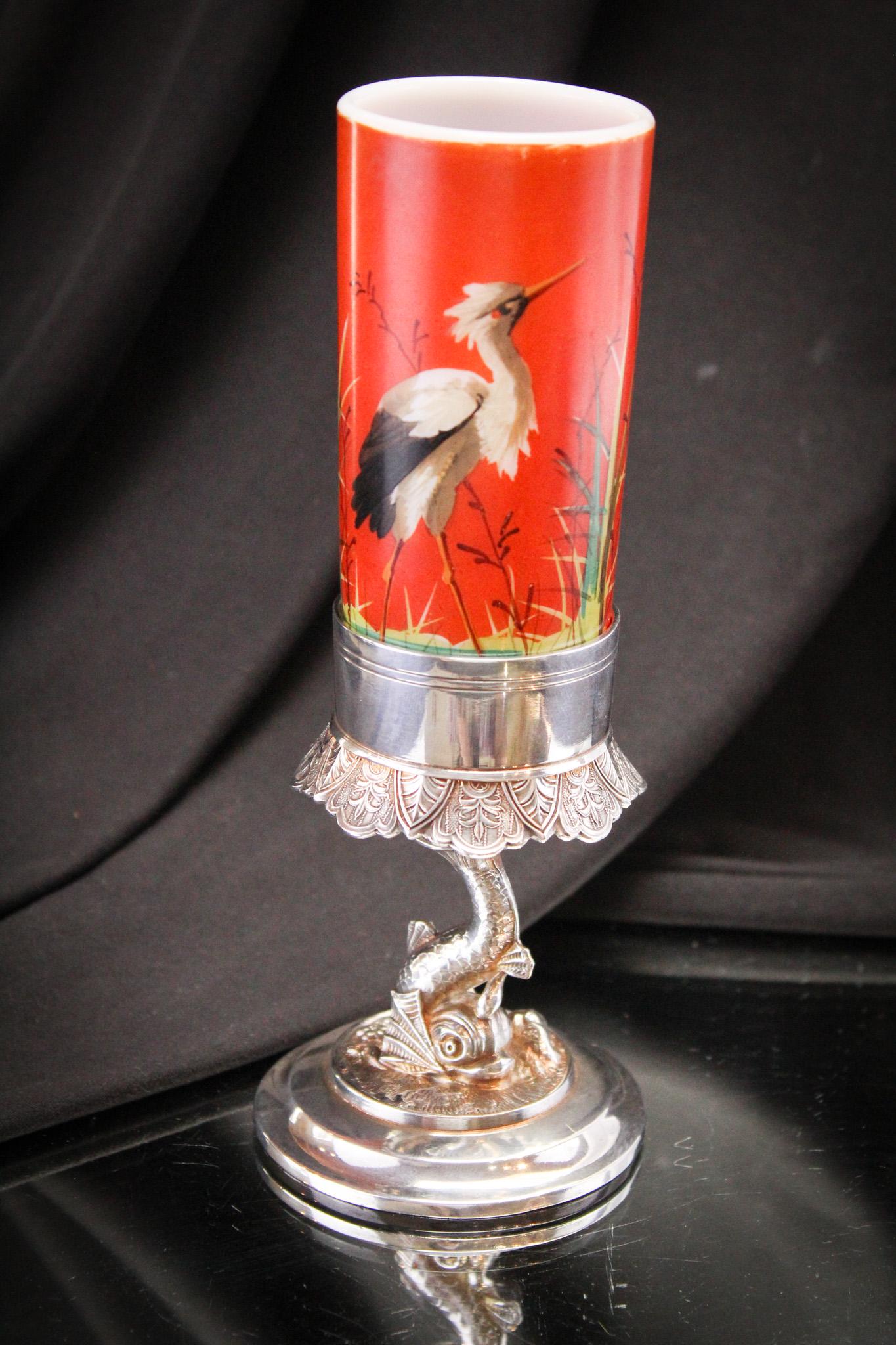 Meriden Figural Dolphin Silverplate Victorian Cylinder Vase: Great cylinder vase with hand painted crane residing in a signed Meriden silverplate Victorian figural dolphin holder. Piece measures 7 1/2" tall.