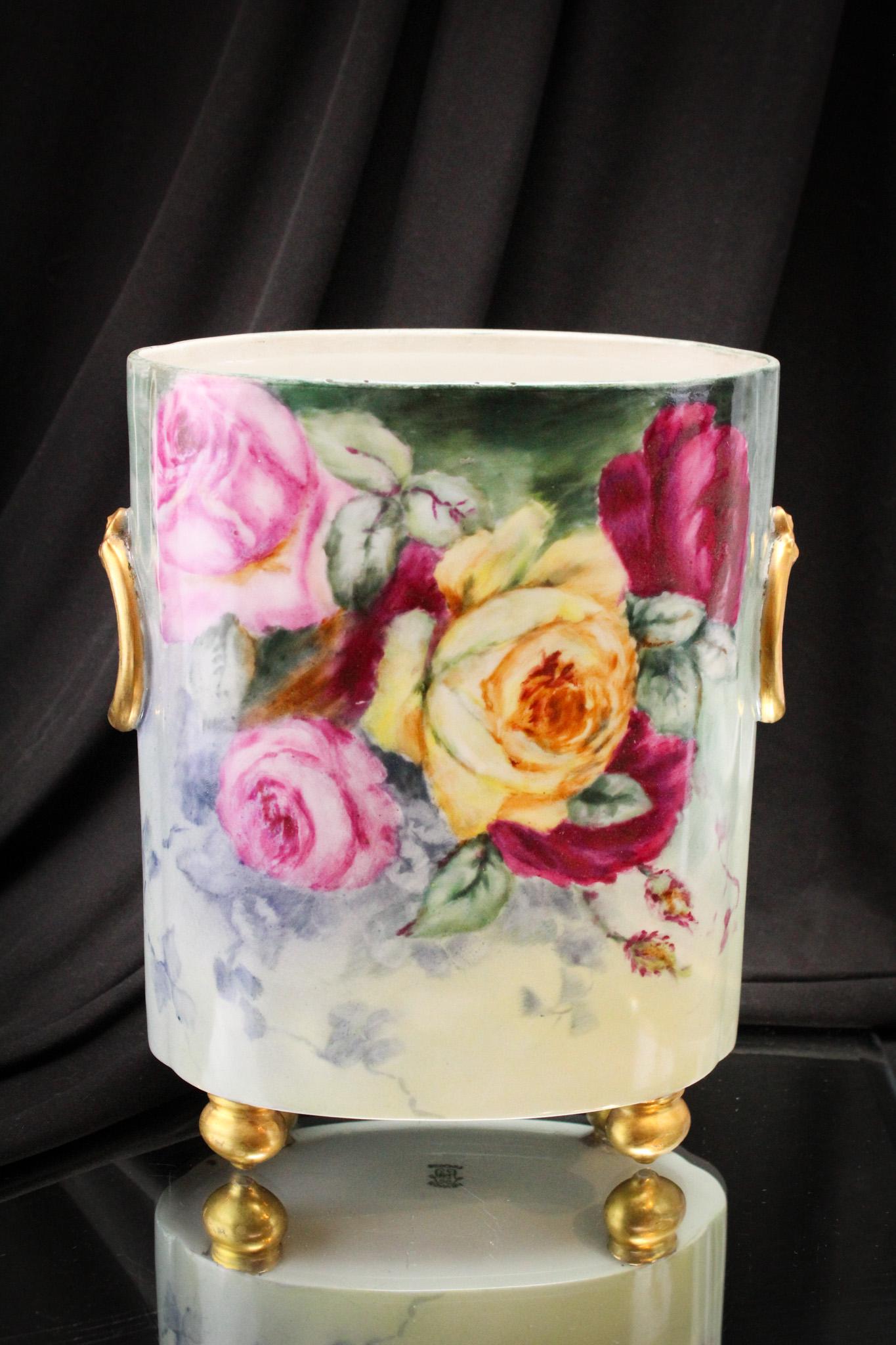 Limoges Hand Painted Porcelain Roses DÃ©cor Cache Pot: Gilt handles just add to the impressive nature of this fine piece. It is decorated with garden roses and stands a tall 9 1/2" on all four feet.