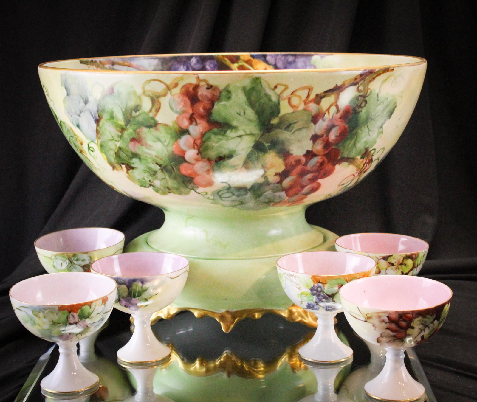 Limoges France Grapes & Gold Hand Painted Porcelain 8pc Punch Set: Very showy hand painted porcelain Limoges France marked eight piece punch set. Set is comprised of punch bowl, base, and set of six cups. Large measuring in at 9 1/2" by 14" in diameter.